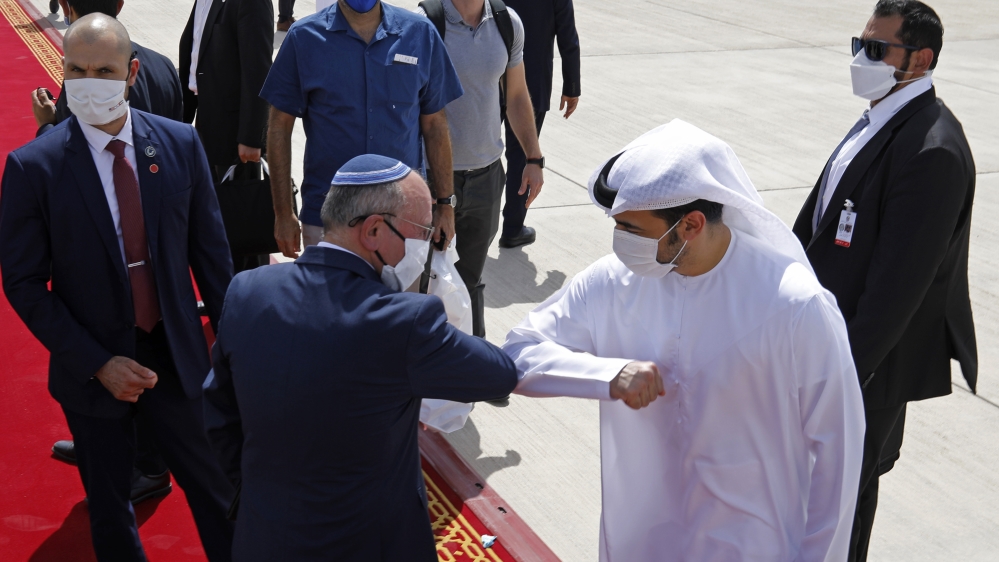 Israeli National Security Advisor Meir Ben-Shabbat, center left, elbow bumps with an Emirati