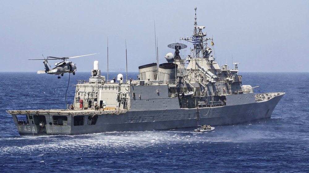 A handout photo released by the Greek National Defence Ministry on August 26, 2020 shows Greek Hydra-class frigate Psara (F-454) of the Hellenic Navy and a military helicopter taking part in a militar
