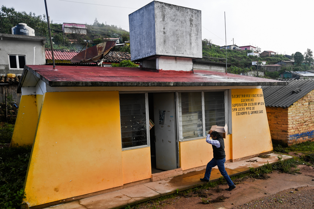 Mexican rural teacher Jaime Bruno, 33, takes books to a school in Cochoapa el Grande, Guerrero state, Mexico, on September 8, 2020, amid the COVID-19 coronavirus pandemic. - Teachers resist abandoning