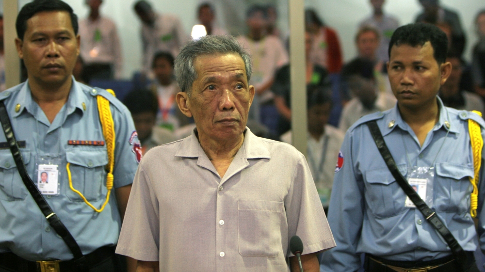 FILE PHOTO: Former Khmer Rouge S-21 prison chief Duch stands in a courtroom during a pre-trial in Phnom Penh