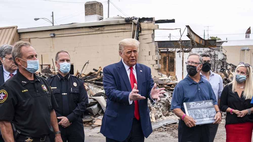 President Donald Trump tours an area on Tuesday, Sept. 1, 2020, damaged during demonstrations after a police officer shot Jacob Blake in Kenosha, Wis. (AP Photo/Evan Vucci)