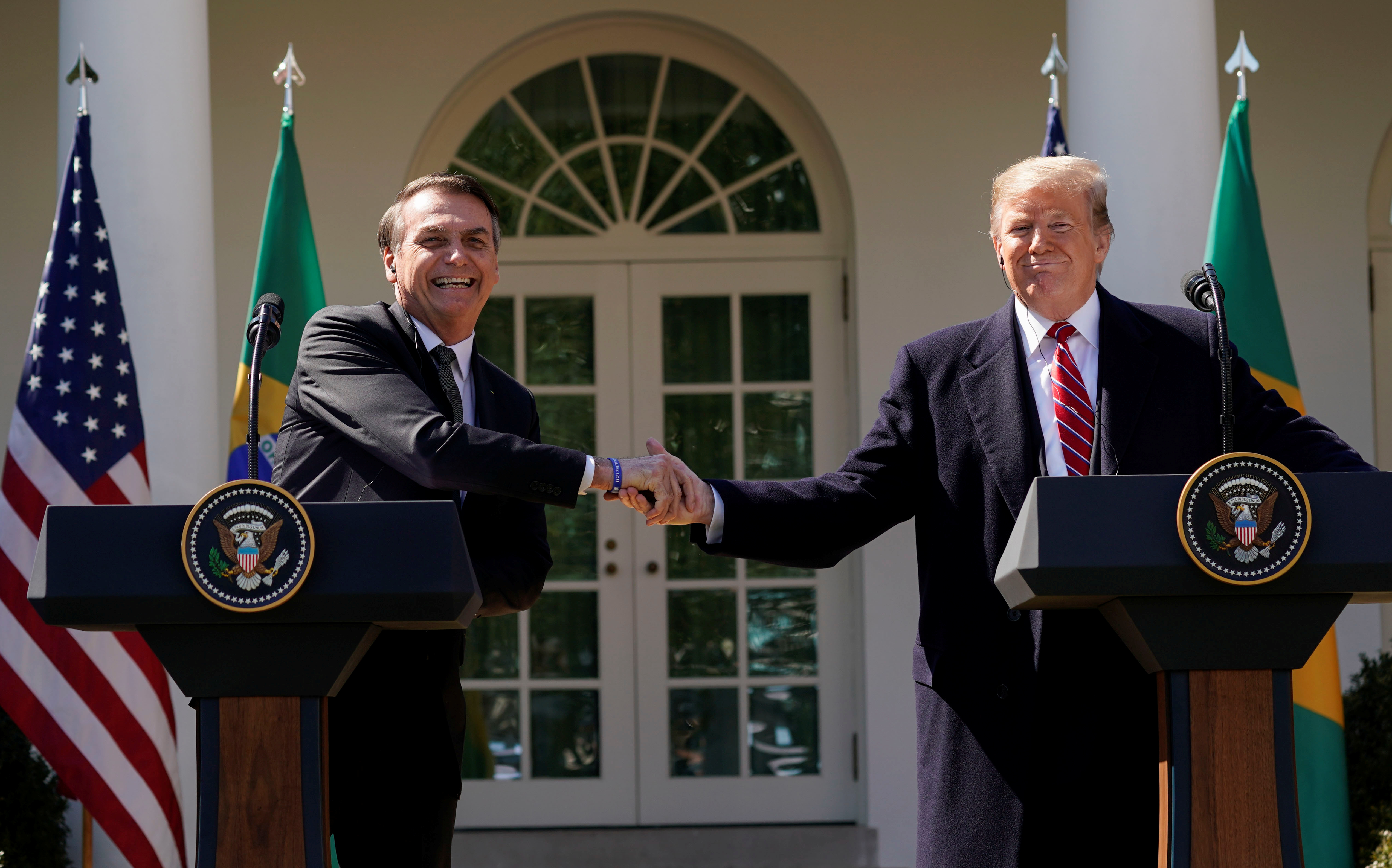 Weeks after Democrat Joe Biden defeated President Donald Trump in the United States election, Bolsonaro (left) still has not recognised Biden's victory [File: Kevin Lamarque/Reuters]