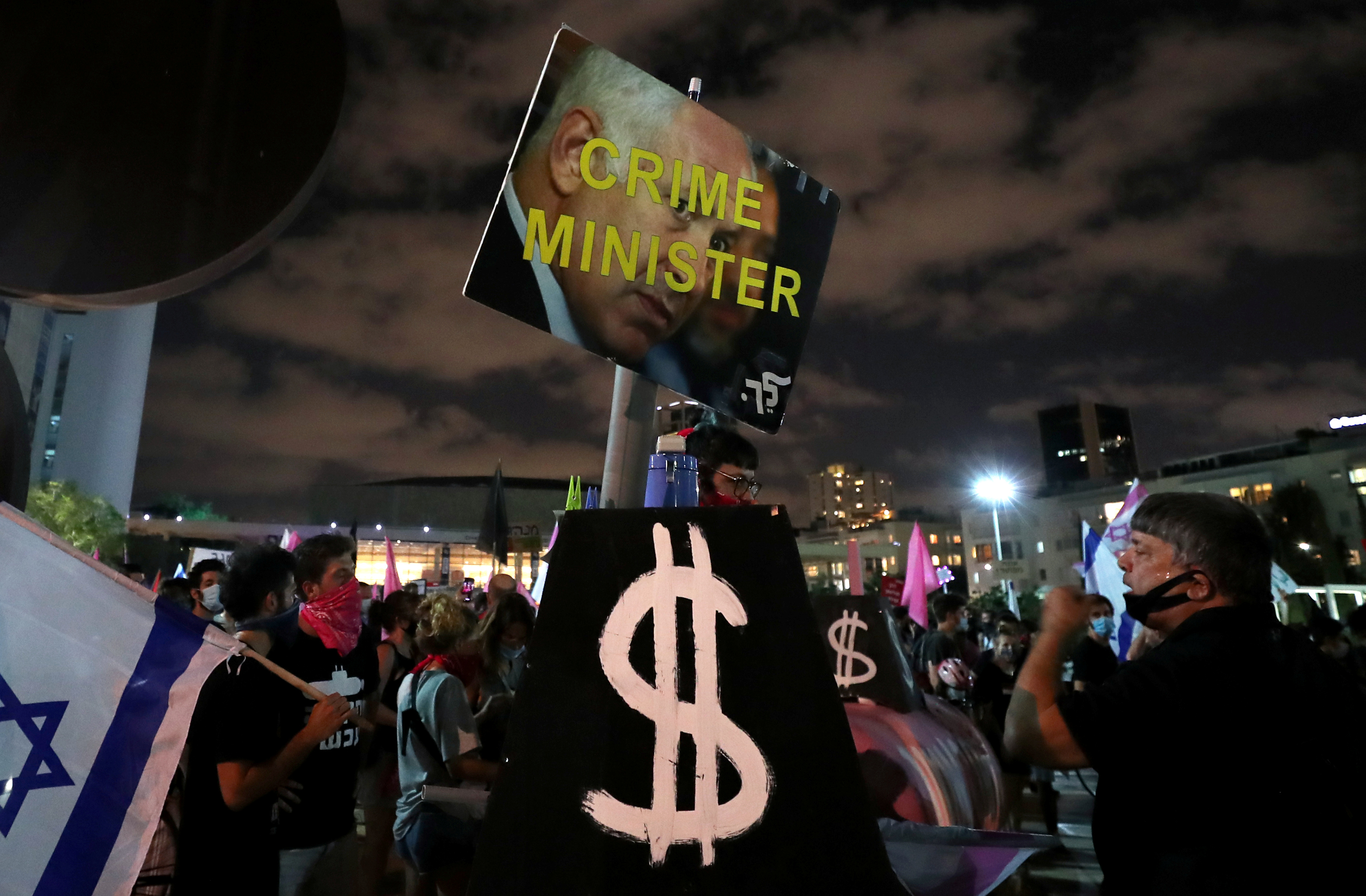 Signs are pictured during a protest against Israeli Prime Minister Benjamin Netanyahu's alleged corruption and the economic hardship stemming from the coronavirus disease (COVID-19) crisis, amid Israel's second nationwide lockdown, in Tel Aviv, Israel October 10, 2020. REUTERS/Ammar Awad