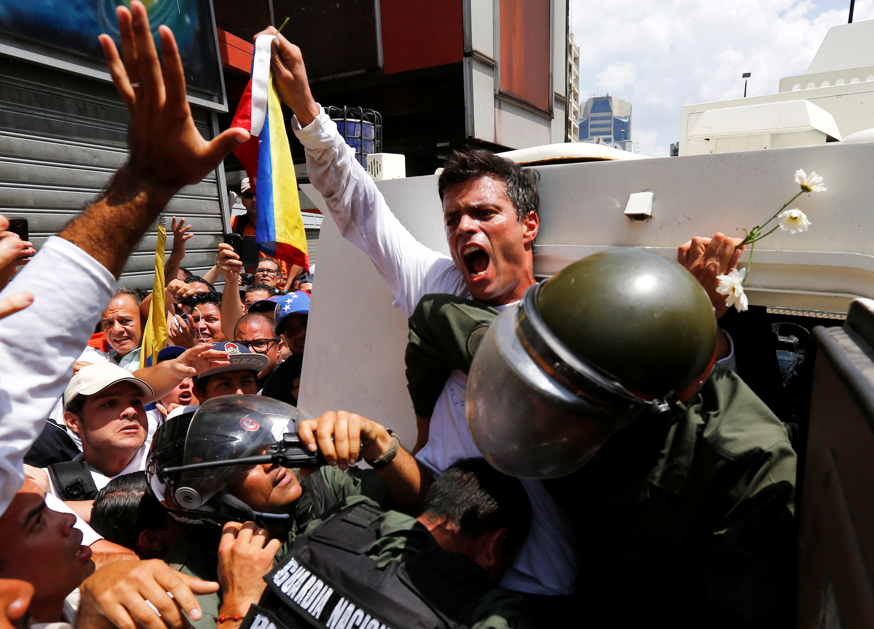 In this file photo from 2014, Venezuelan opposition leader Leopoldo Lopez gets into a National Guard armoured vehicle in Caracas [File: Jorge Silva/Reuters]