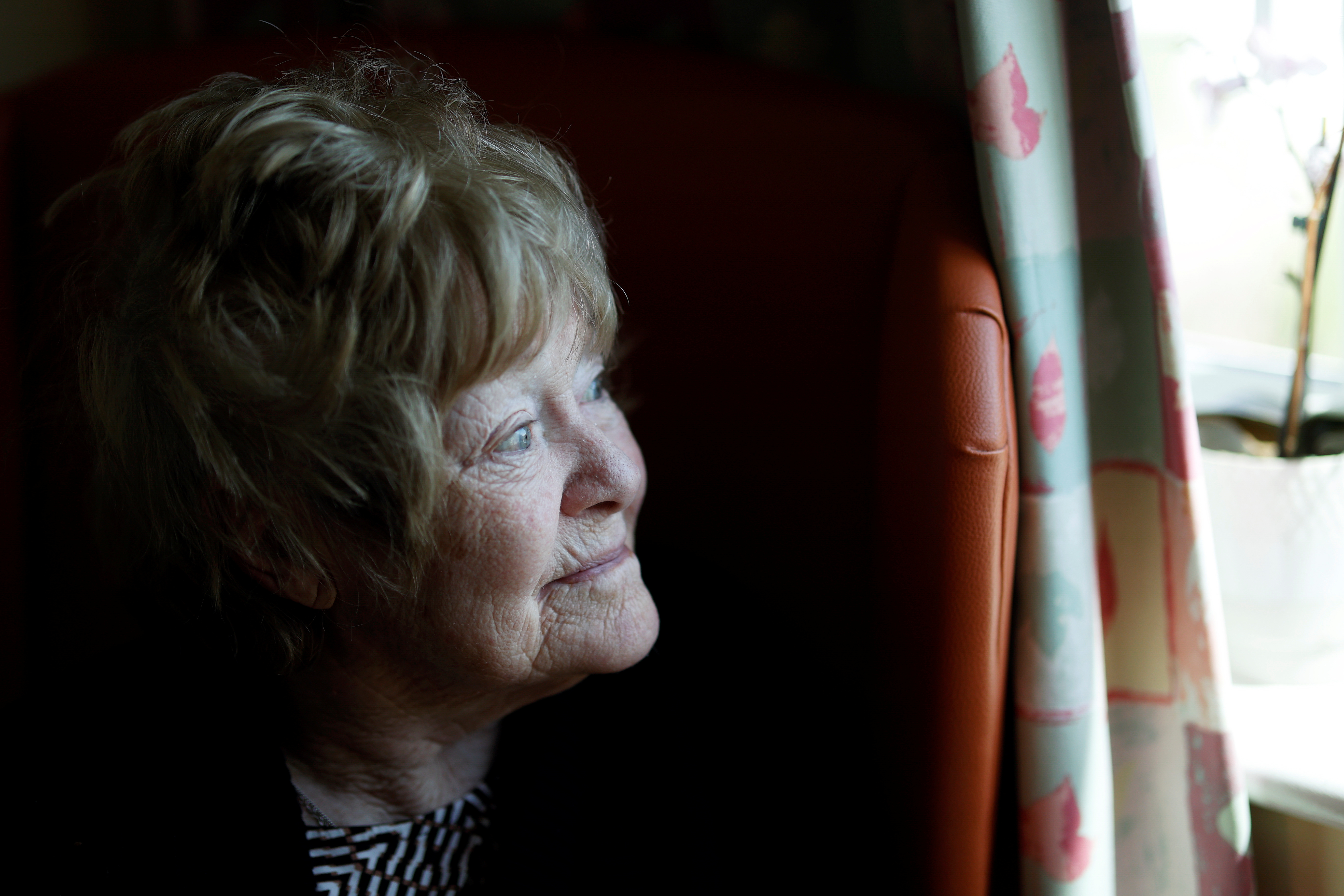 A resident looks out of her bedroom window at Fremantle Trust care home, amid the outbreak of the coronavirus disease (COVID-19), in Princes Risborough, Britain, May 5, 2020 [Eddie Keogh/Reuters]