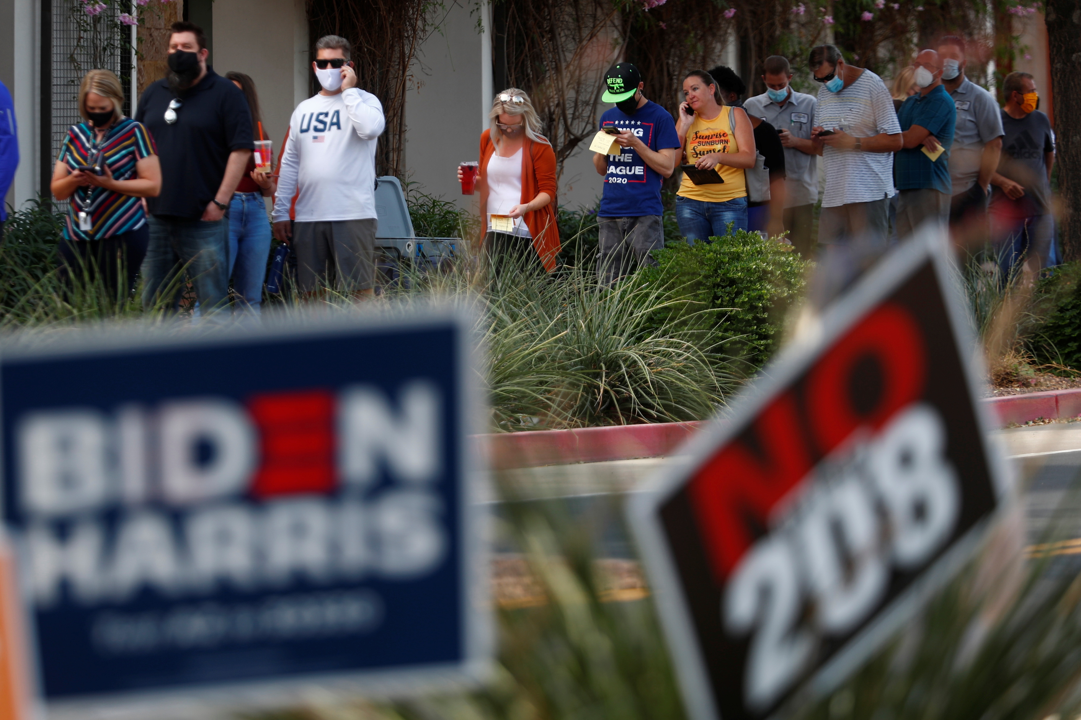 People wait in line to cast their vote at a polling station on Election Day in Surprise, Arizona, US, November 3, 2020 [Edgard Garrido/Reuters]