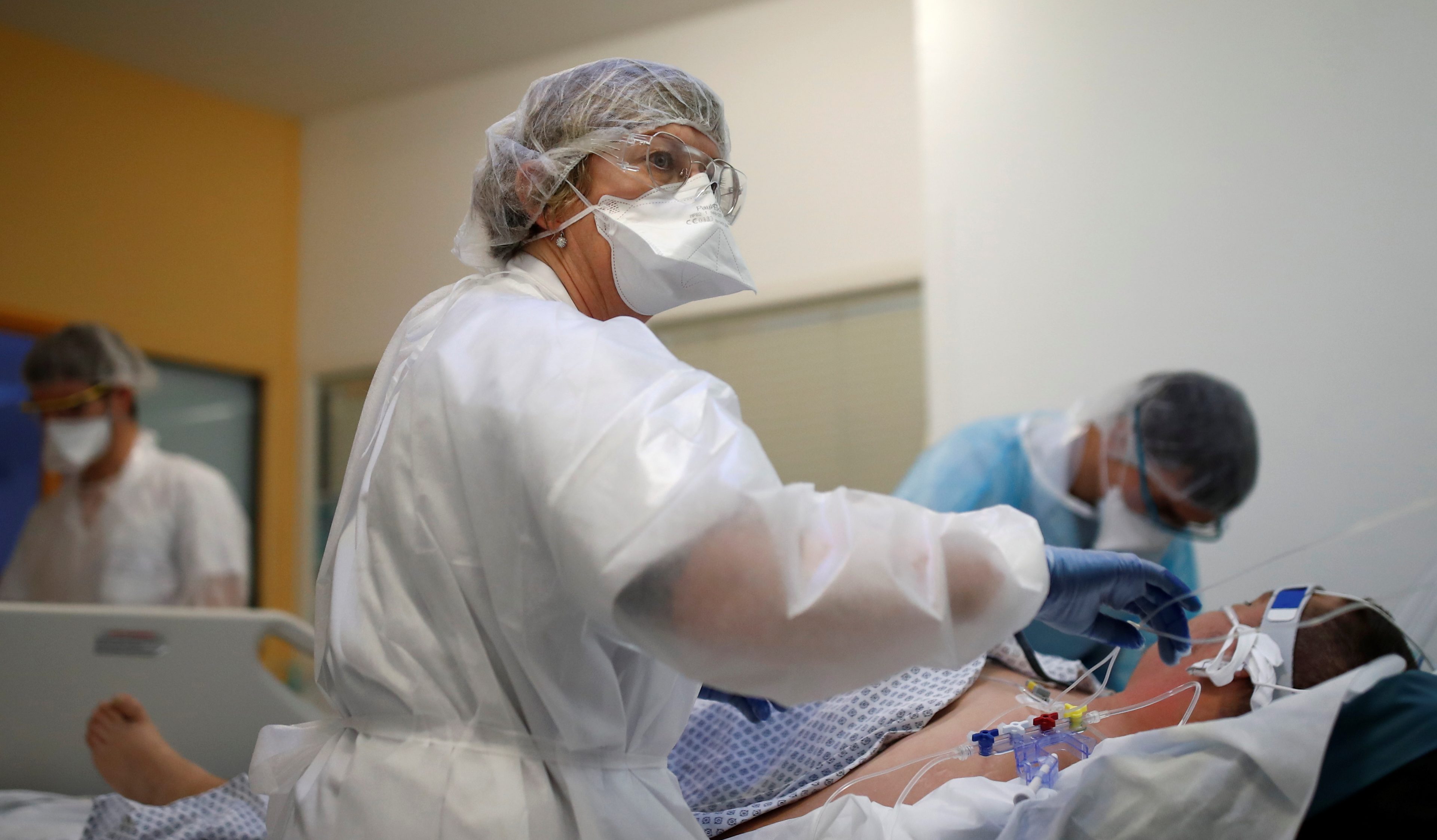 Medical staff work in an intensive care unit where patients with the coronavirus disease (COVID-19) are treated in a hospital in Vannes, France [Stephane Mahe/Reuters]