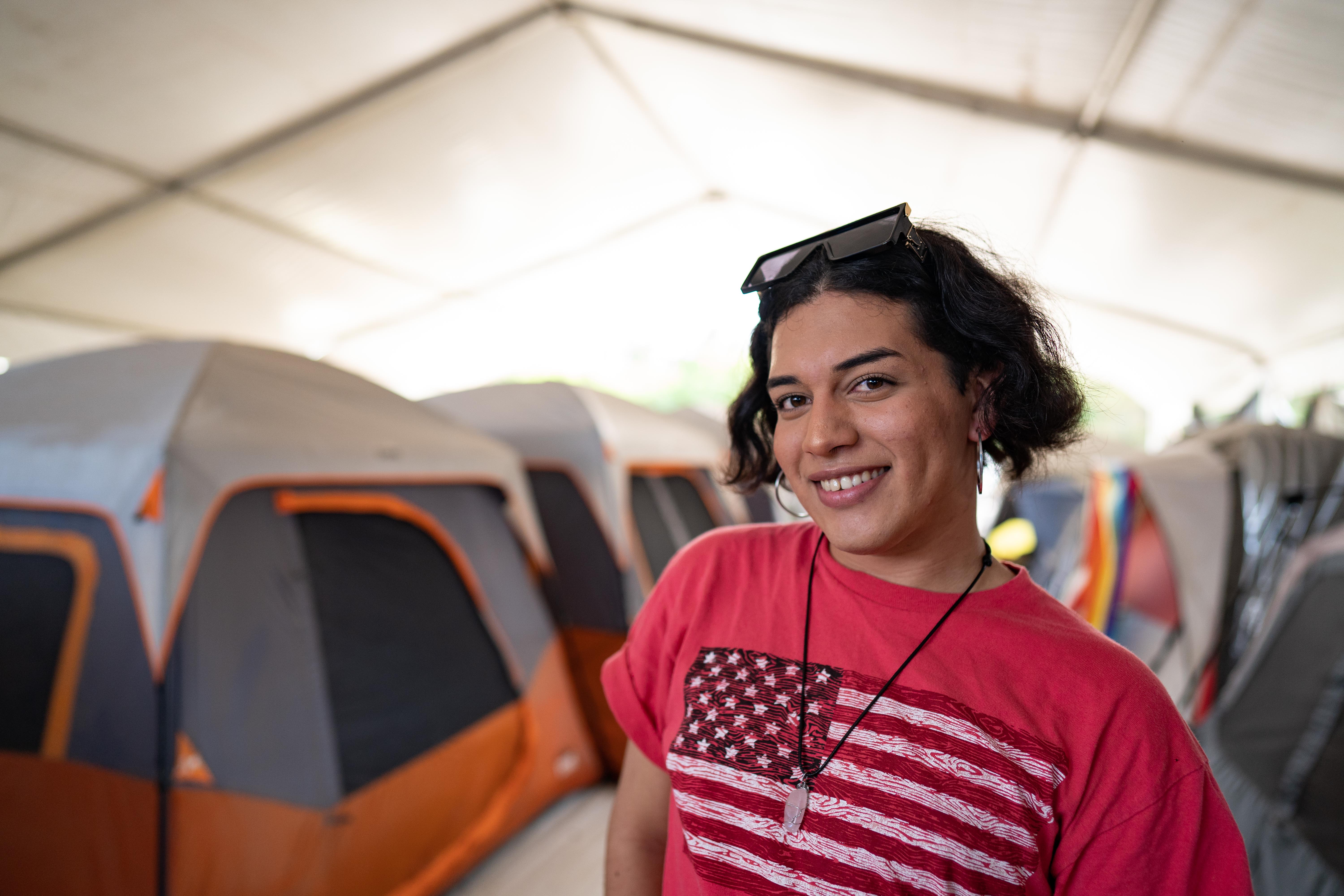 Fernanda poses for a photograph outside her tent [Lexie Harrison-Cripps/Al Jazeera]