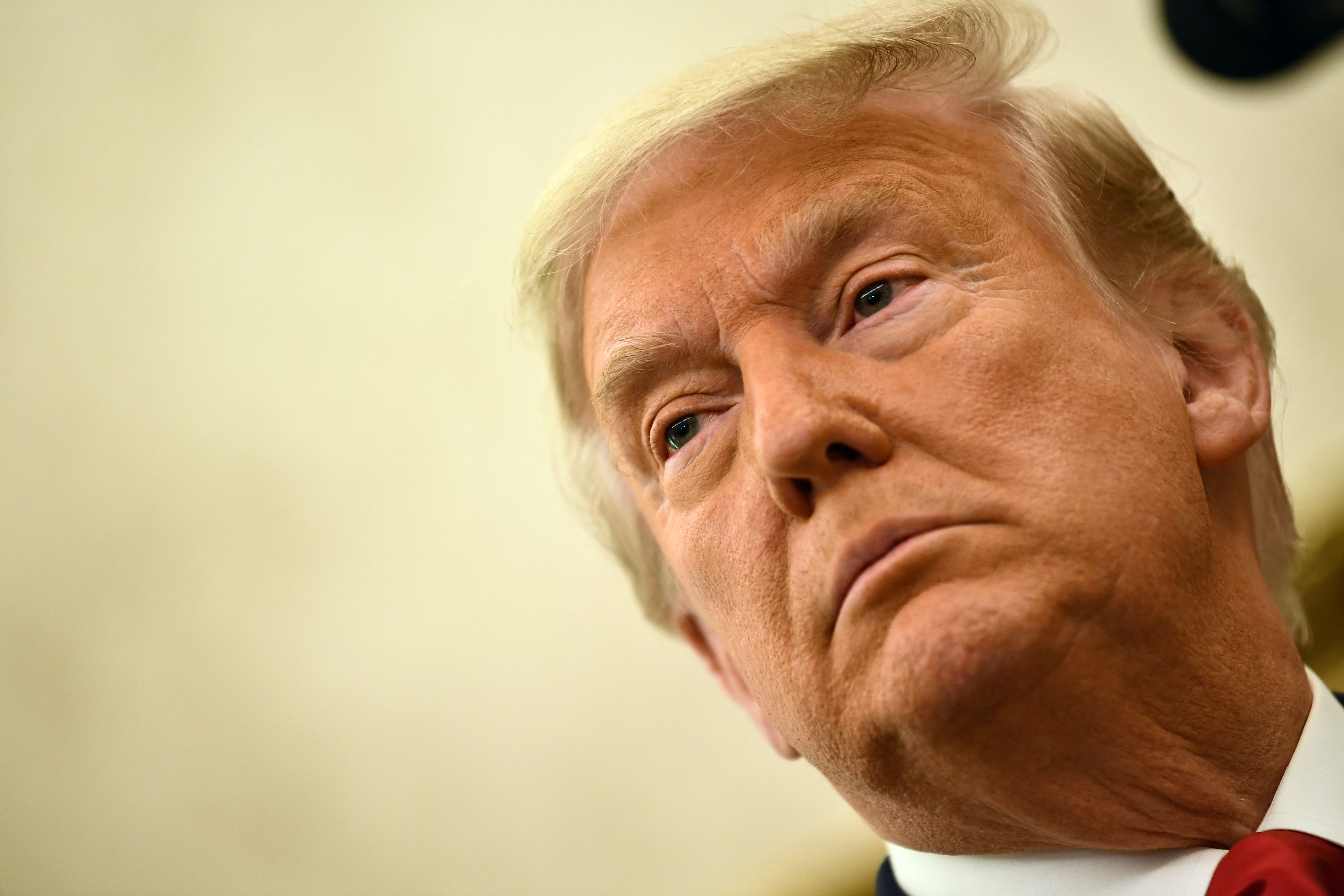 (FILES) In this file photo taken on December 3, 2020 US President Donald Trump speaks before awarding the Presidential Medal of Freedom to retired football coach Lou Holtz in the Oval Office of the White House in Washington, DC. - An angry backlash December 23 met US President Donald Trump's pardons of corrupt Republican congressmen and security guards convicted of killing 14 civilians in a 2007 Baghdad massacre. Trump is believed to be weighing other pardons including members of his family, his personal lawyer Rudy Giuliani, and potentially himself, to protect from potential litigation after he steps down on January 20. (Photo by Brendan Smialowski / AFP)