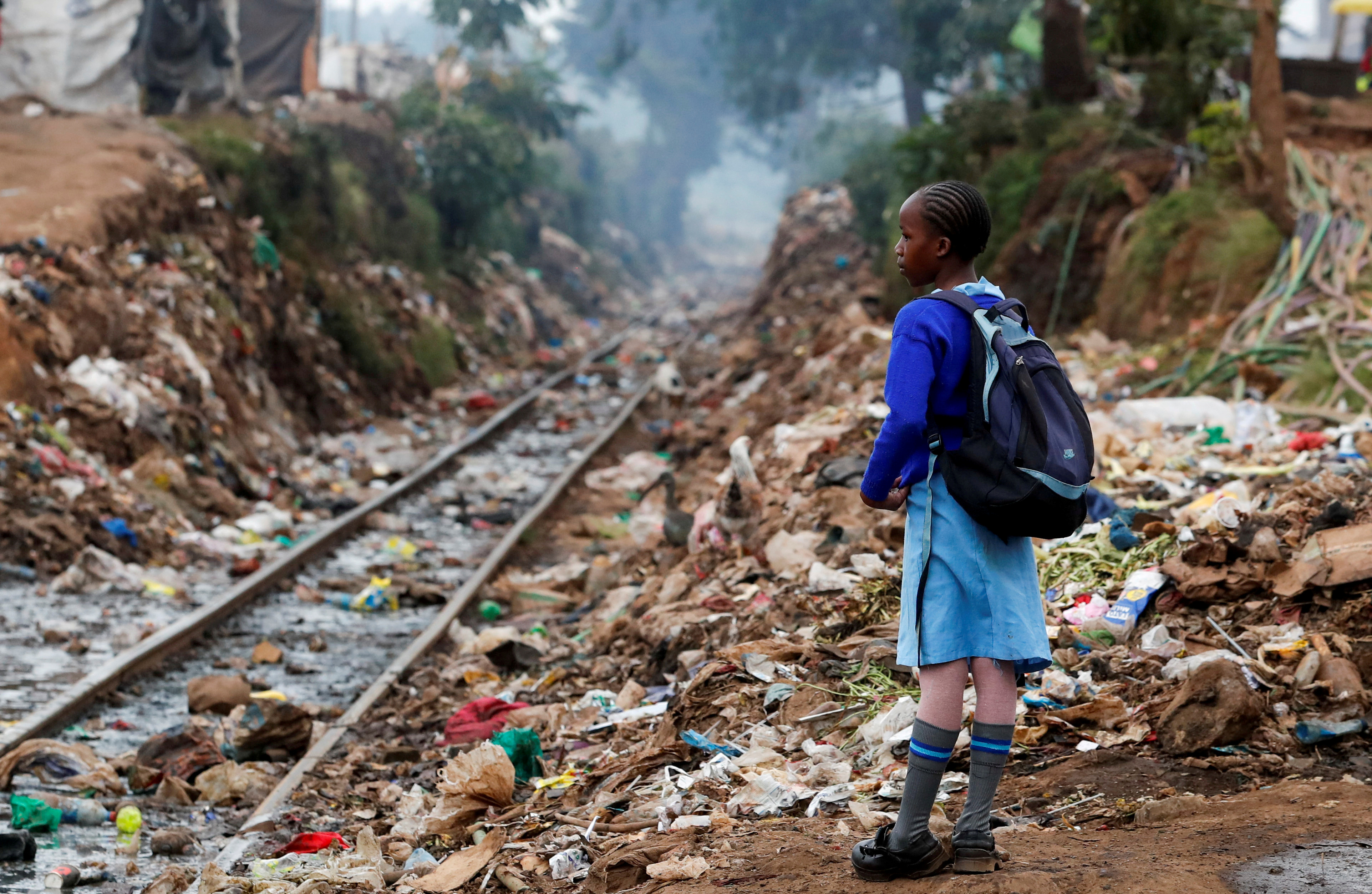 Schoolgirl stands with backpack