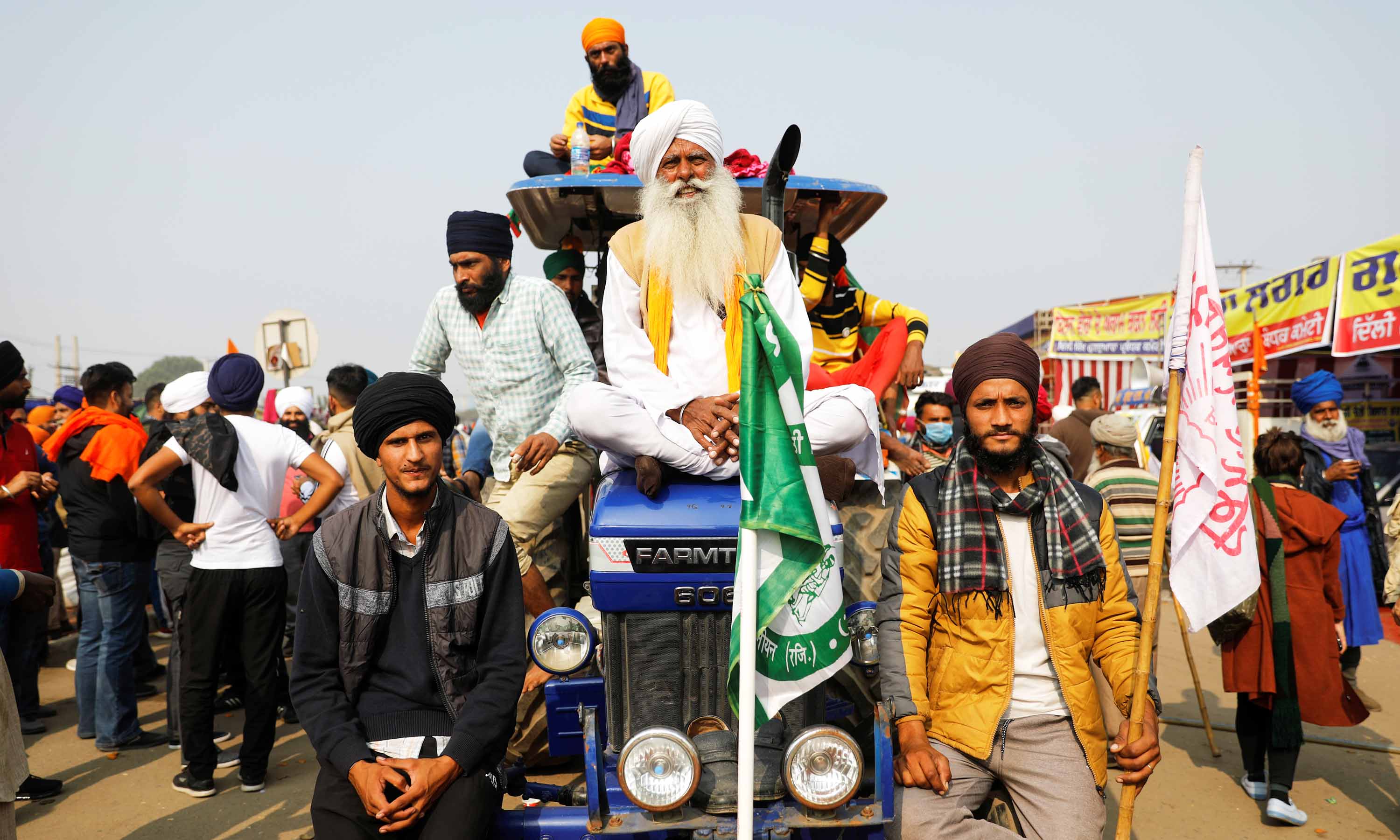 Farmers sit on a tractor during a protest against recently passed farm bills at the Singhu border near Delhi, India on December 5, 2020 [Reuters/Adnan Abidi]
