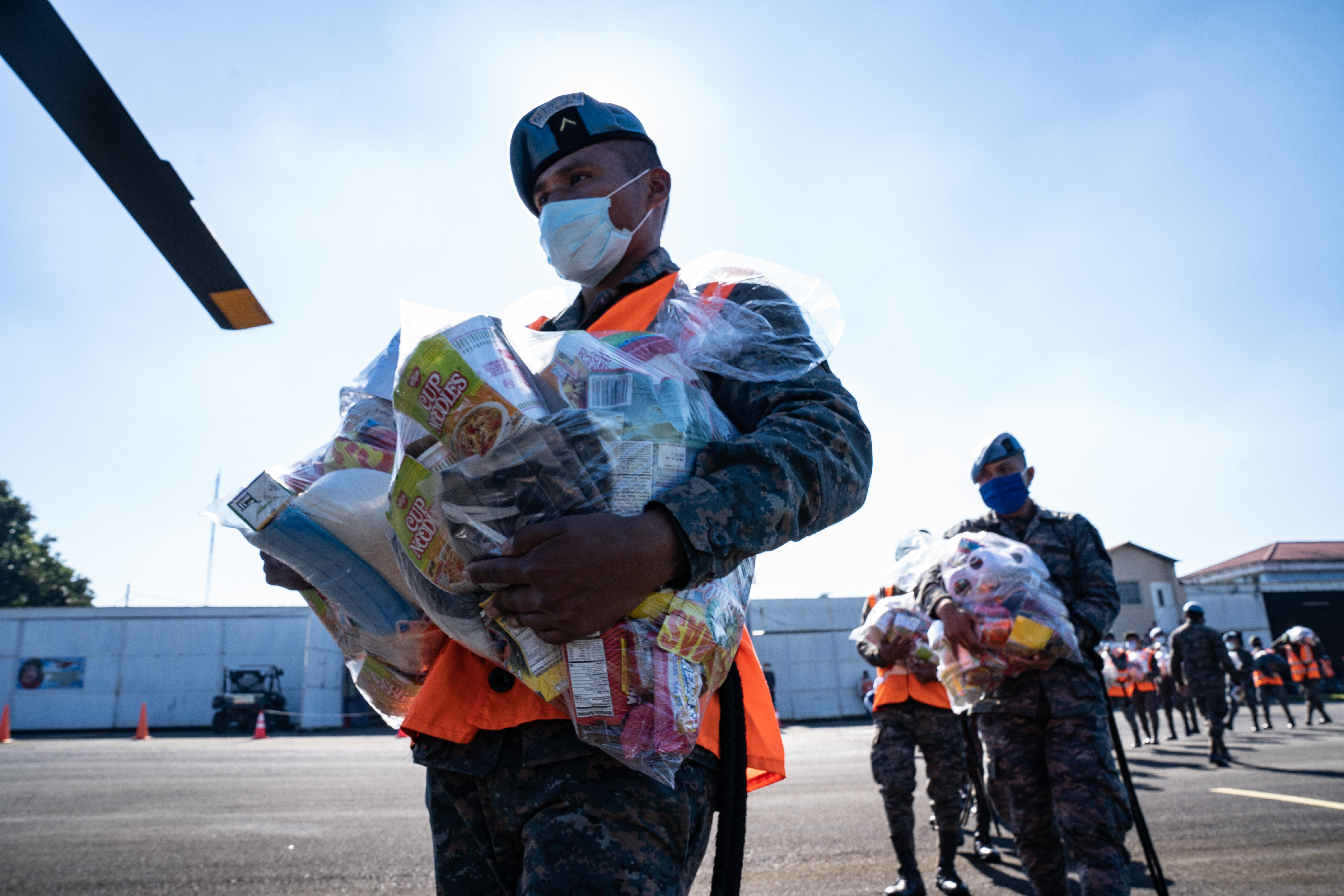 Members of the Guatemalan armed forces load up food onto a helicopter on the Coban airfield in Alta Verapaz, Guatemala [Lexie Harrison-Cripps/Al Jazeera]