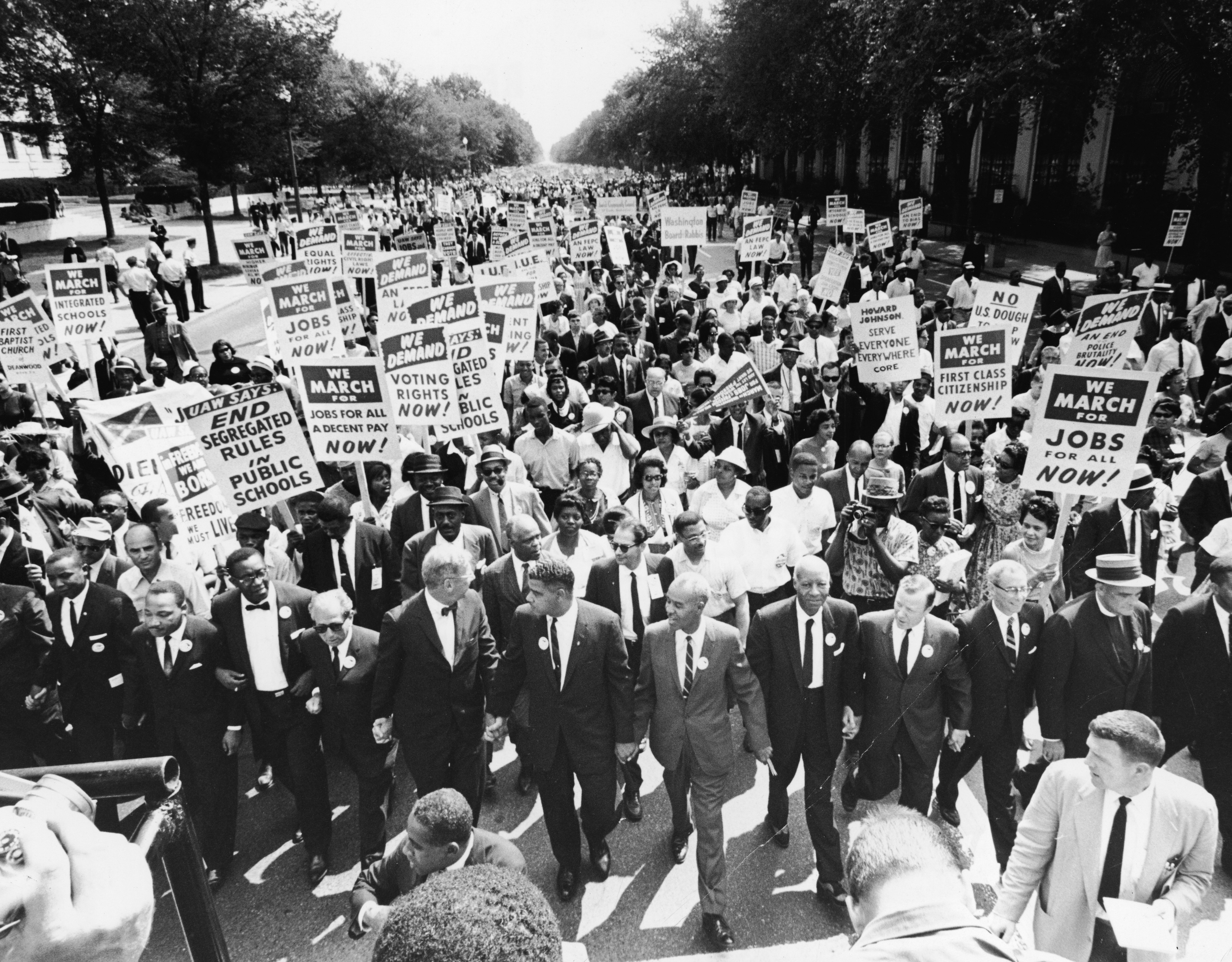 Civil rights leaders hold hands as they lead a crowd of hundreds of thousands at the March on Washington for Jobs and Freedom, Washington DC, August 28, 1963 [File: Express/Hulton Archive/Getty Images]