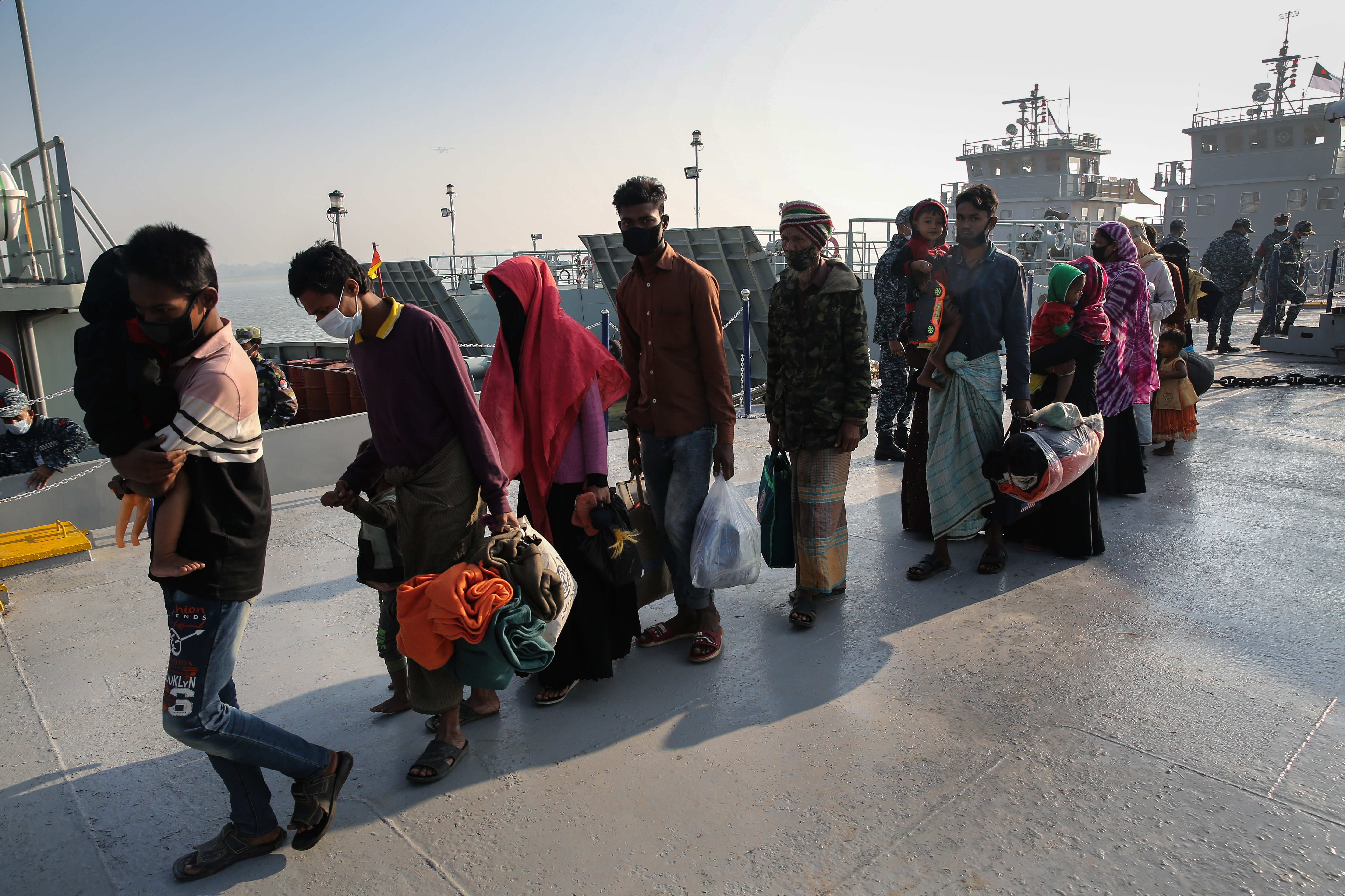 Rohingya refugees prepare to board a ship as they move to Bhasan Char island near Chattogram [Mahmud Hossain Opu/Al Jazeera]