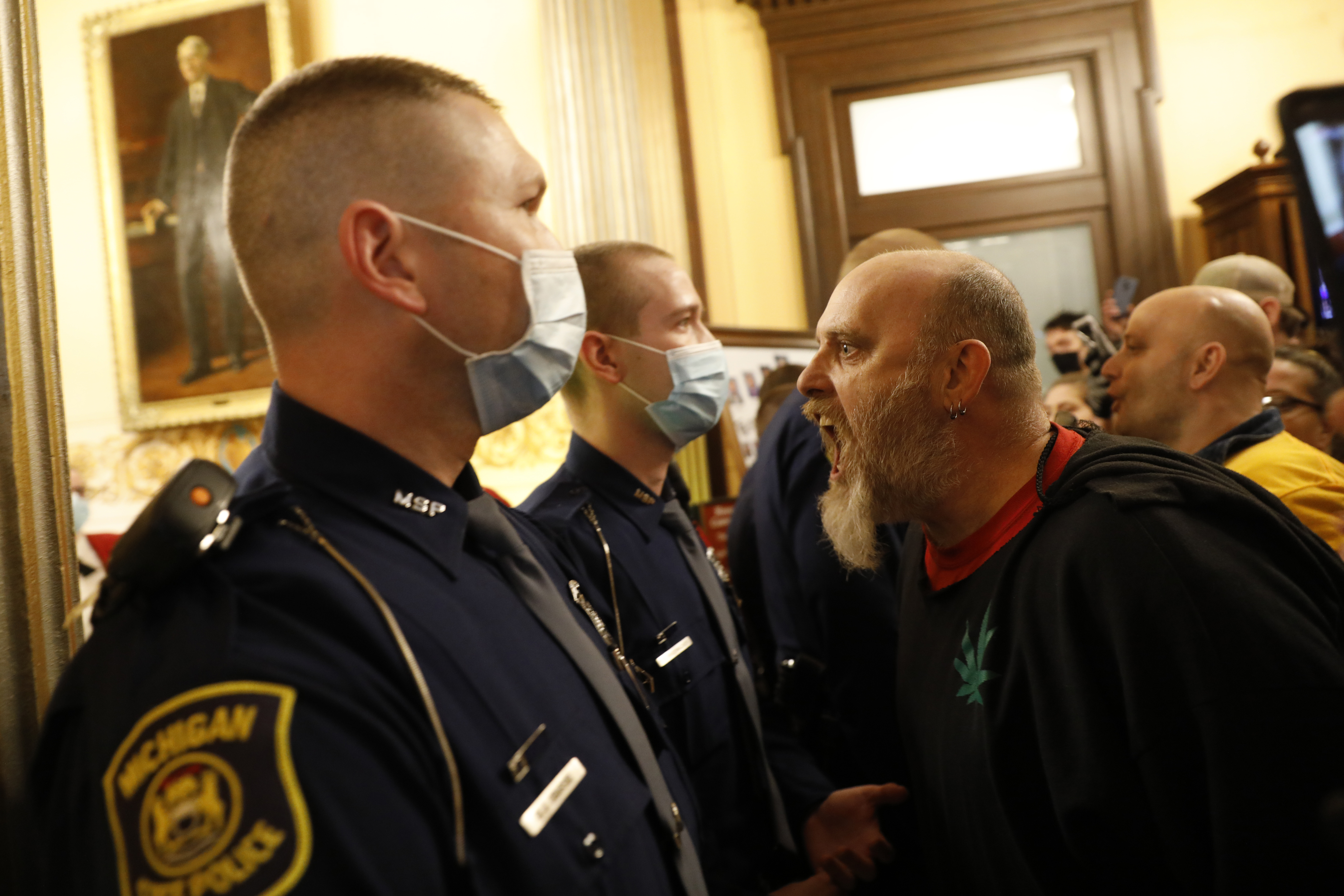 Protesters try to enter the Michigan House of Representative chamber and are being kept out by the police after the American Patriot Rally organised by Michigan United for Liberty protest for the reopening of businesses on the steps of the Michigan State Capitol in Lansing, Michigan, US, on April 30, 2020 [File: Jeff Kowalsky/AFP]