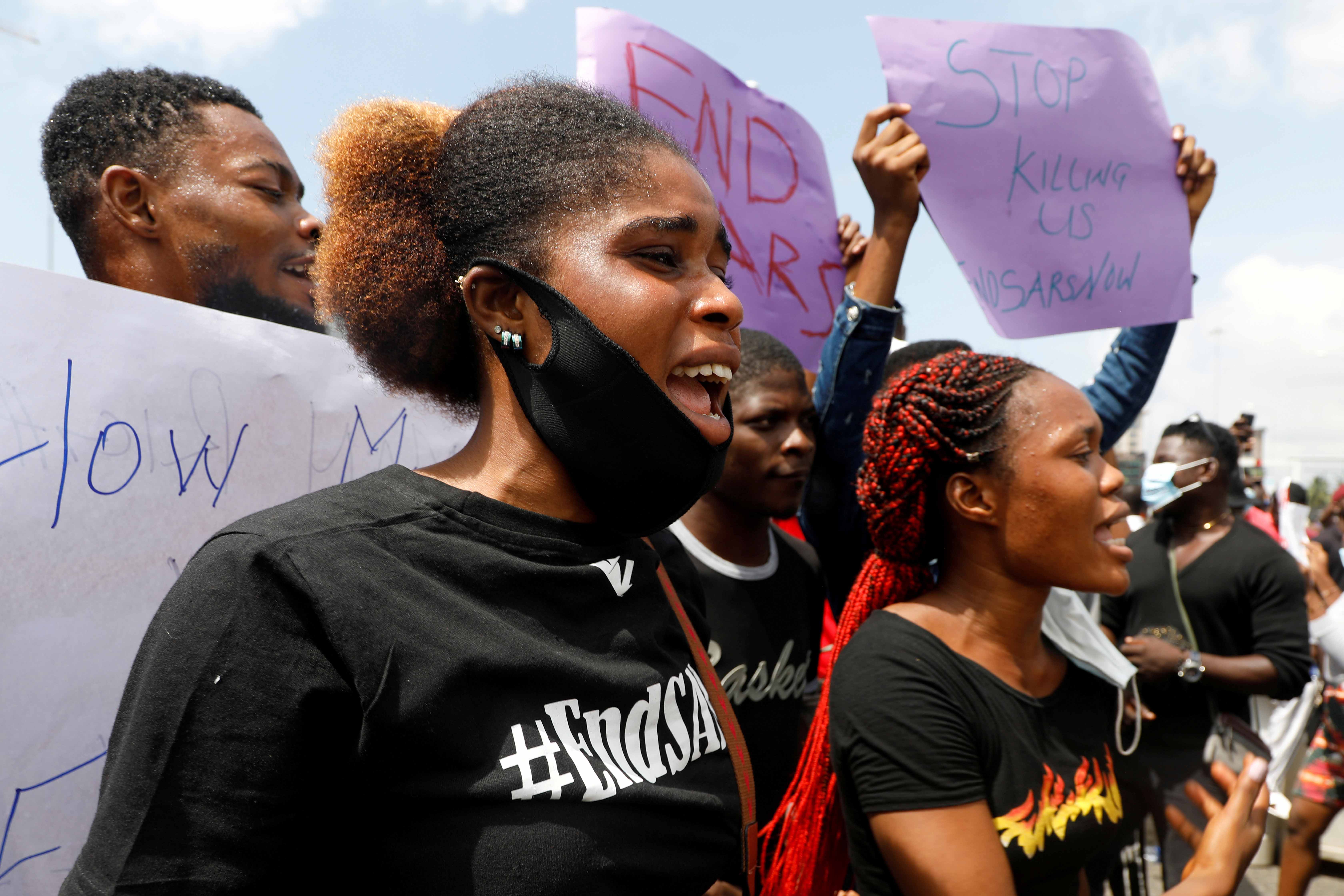 Demonstrators hold banners and shout slogans during a protest against police brutality, in Lagos, Nigeria on October 12, 2020 [Reuters/Temilade Adelaja]