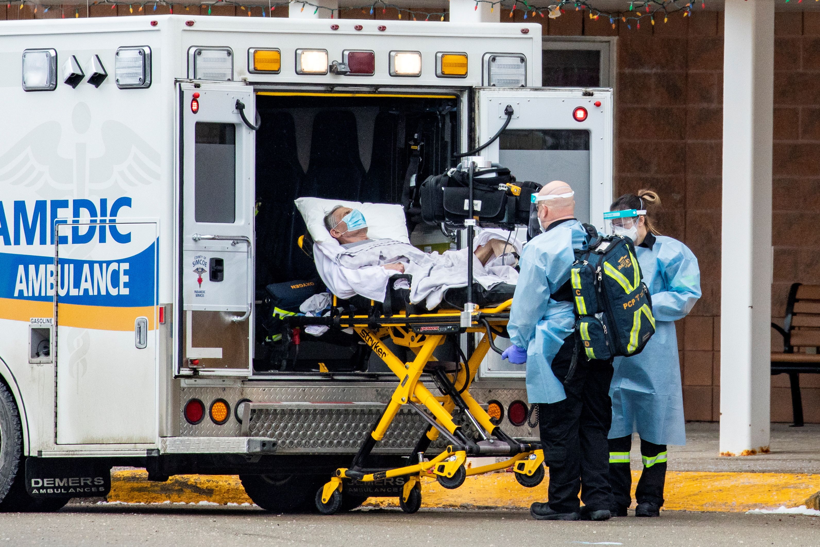 Paramedics transport a person from Roberta Place, a long-term elderly care facility in Barrie, Ontario, on January 18 [Carlos Osorio/Reuters]
