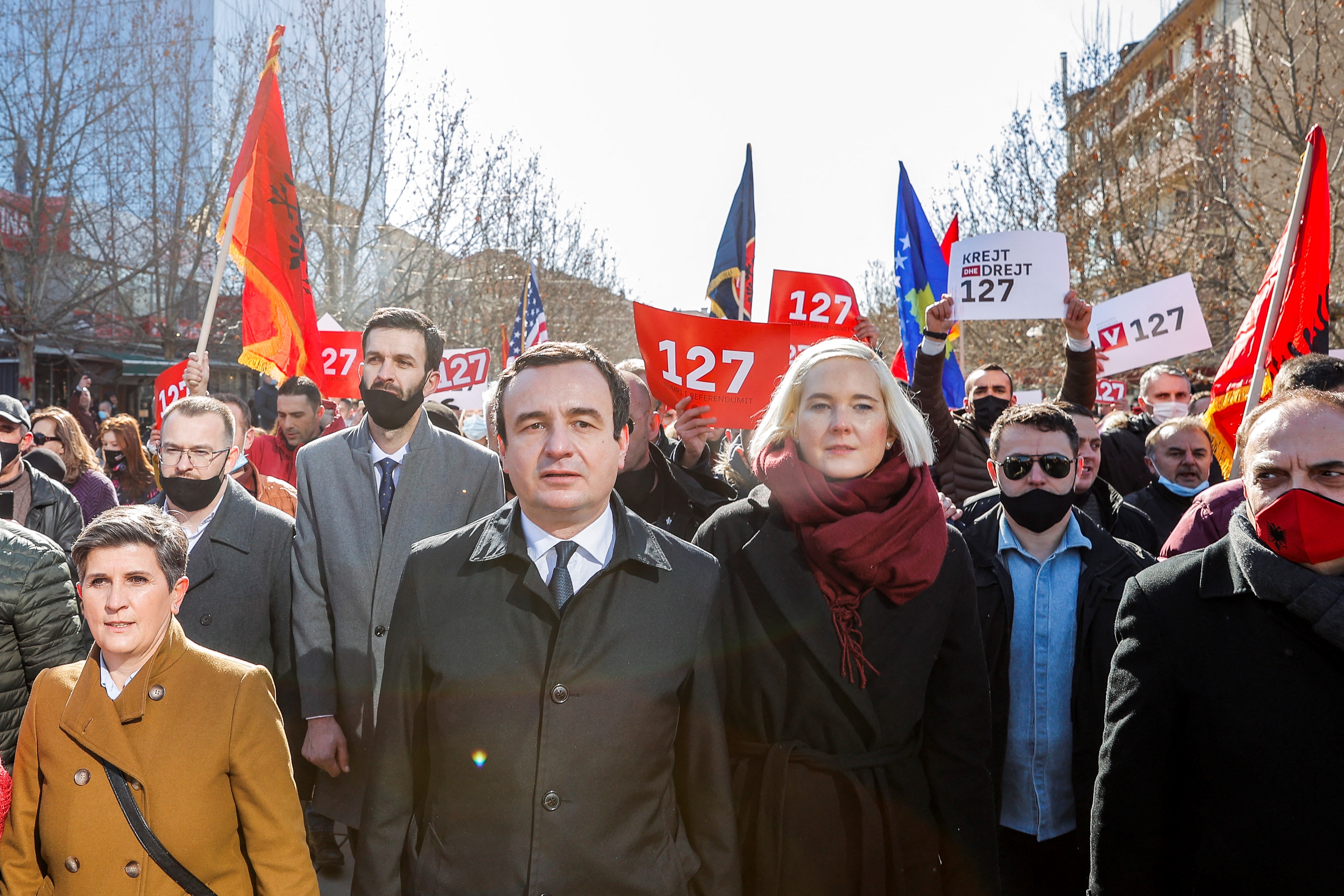 Leader of the Movement for Self-Determination Albin Kurti, flanked by his wife, takes part in a rally on the last day of campaigning for the parliamentary elections in Pristina on February 12, 2021 [AFP/Stringer]