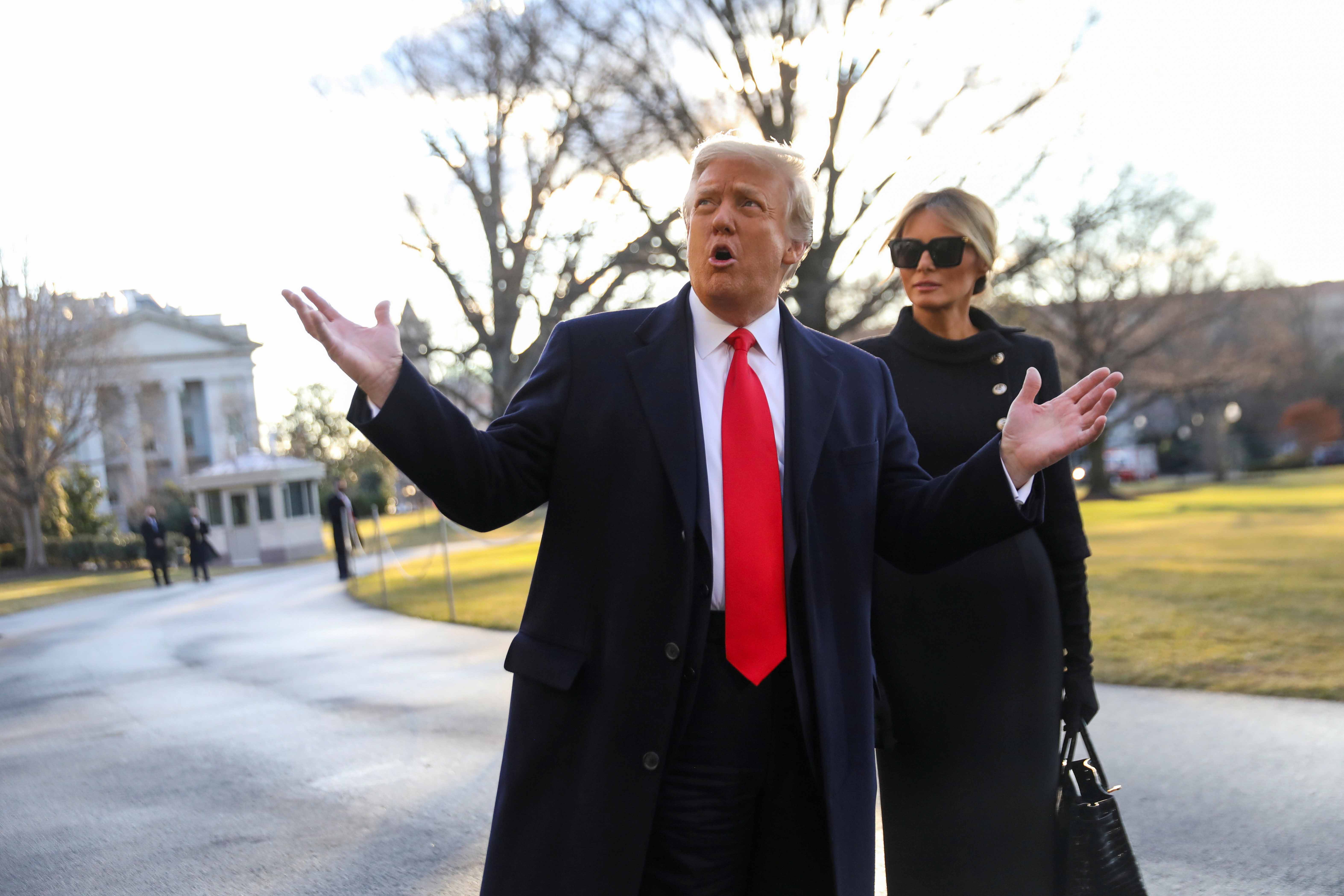 US President Donald Trump gestures as he and first lady Melania Trump depart the White House ahead of the inauguration of president-elect Joe Biden in Washington on January 20, 2021 [Reuters/Leah Millis]