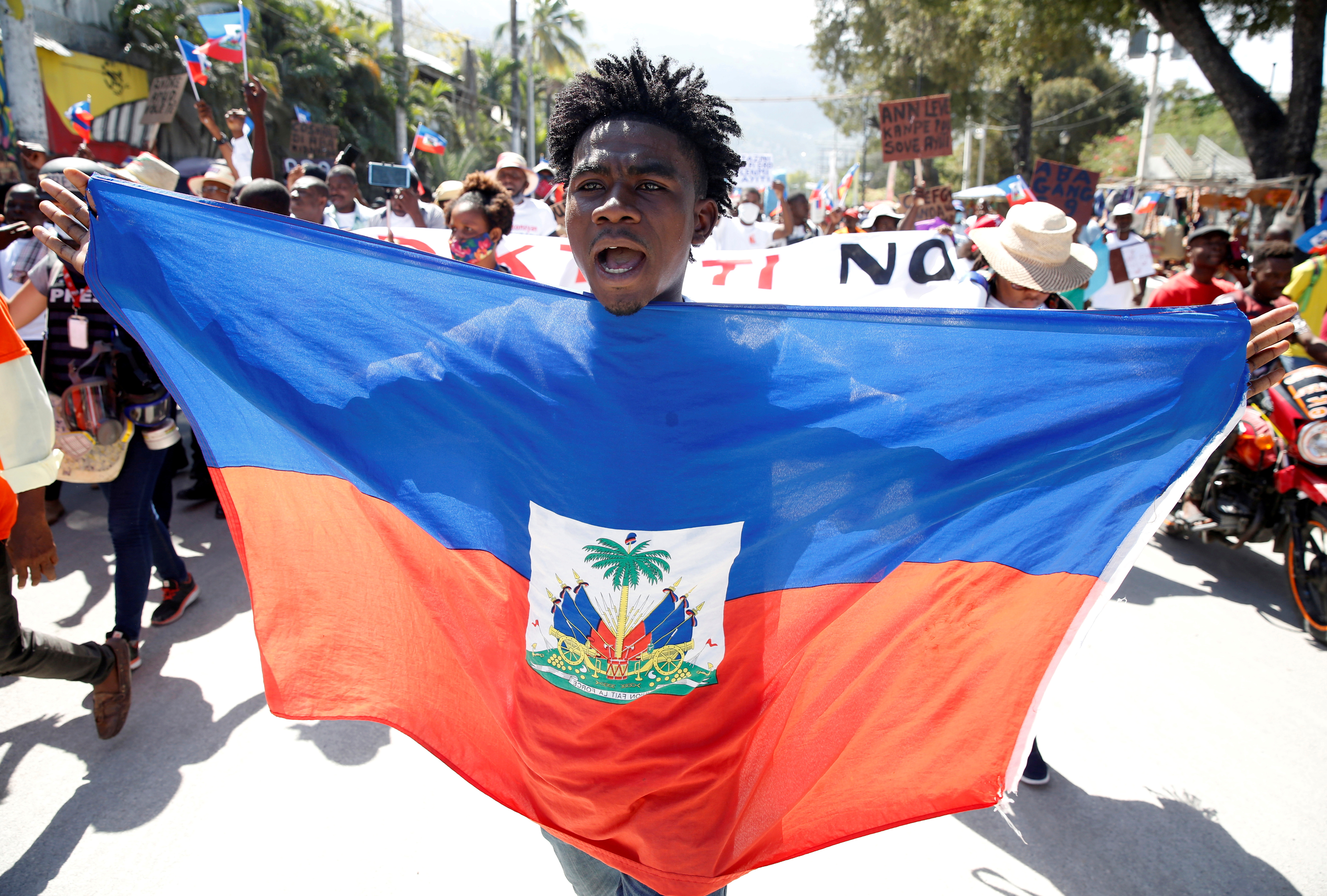 A demonstrator takes part in a protest against Haiti's President Jovenel Moise, in Port-au-Prince, on February 14 [Jeanty Junior Augustin/Reuters]