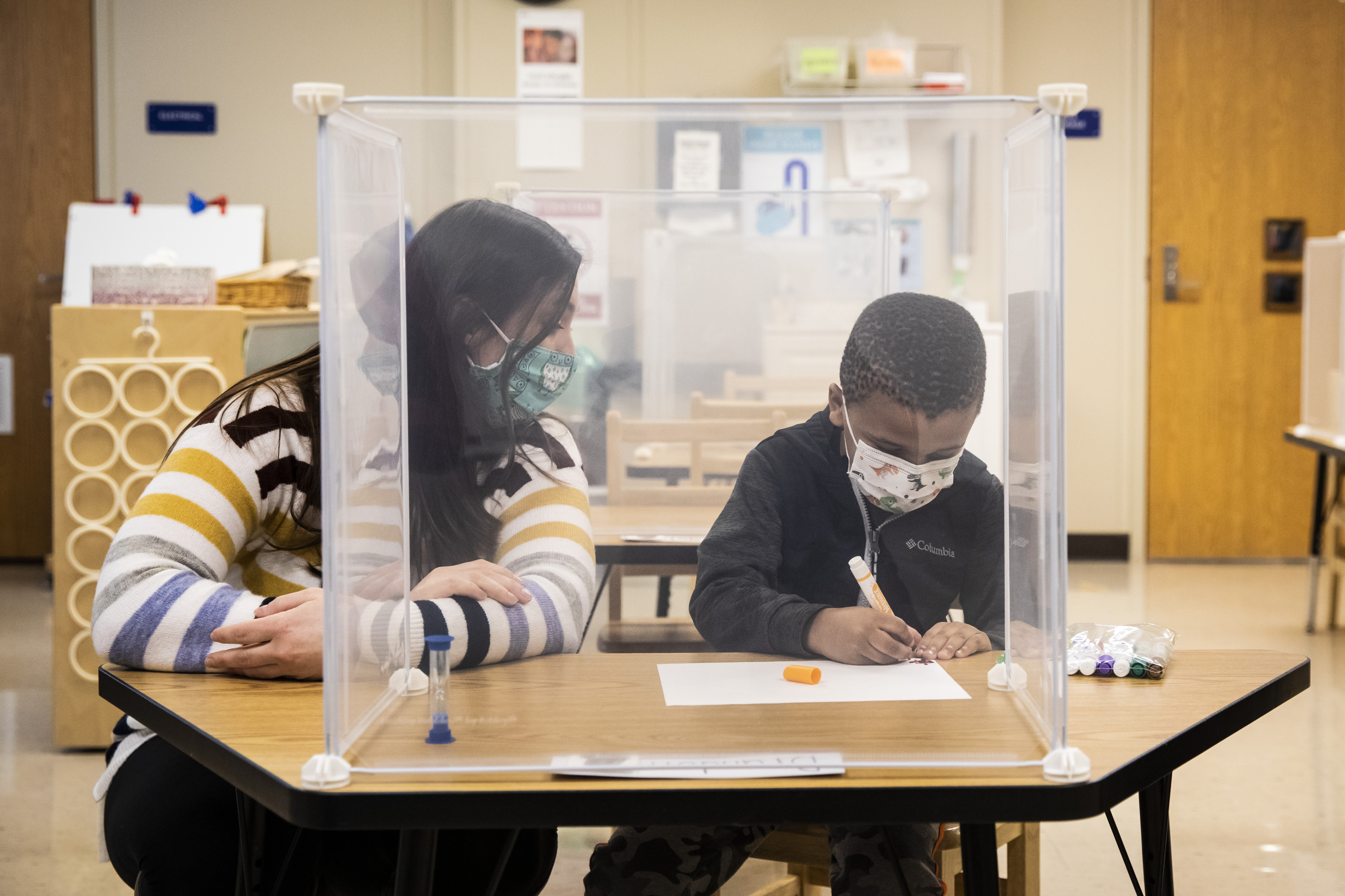 Pre-kindergarten teacher Sarah McCarthy works with a student at Dawes Elementary in Chicago.