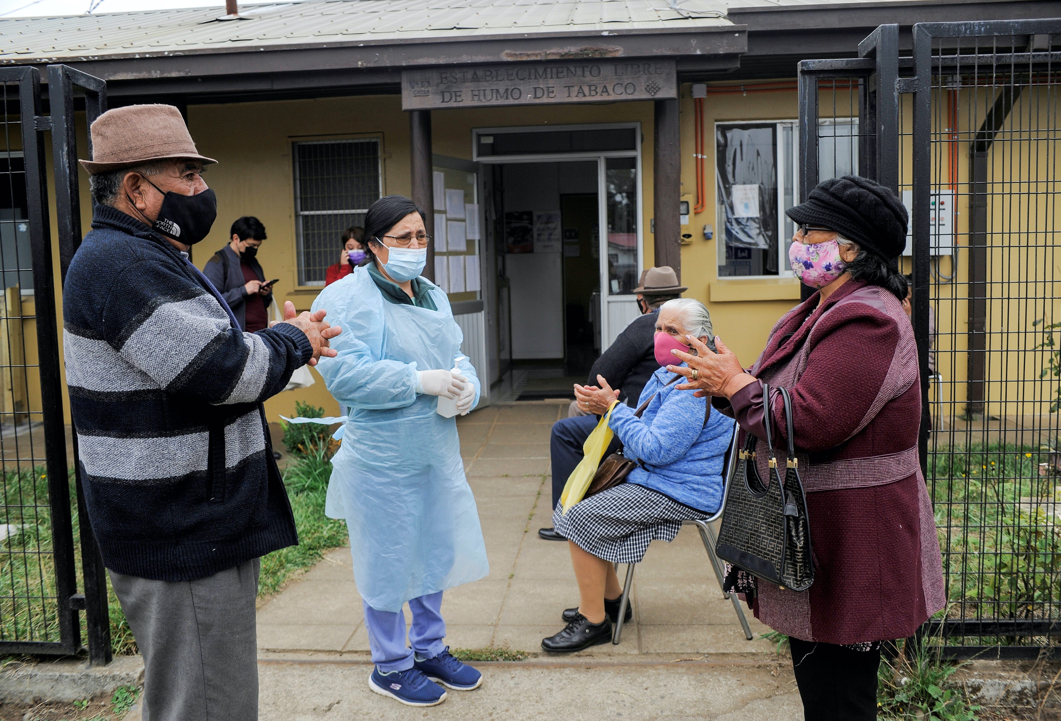 A group of people wait to receive the vaccine