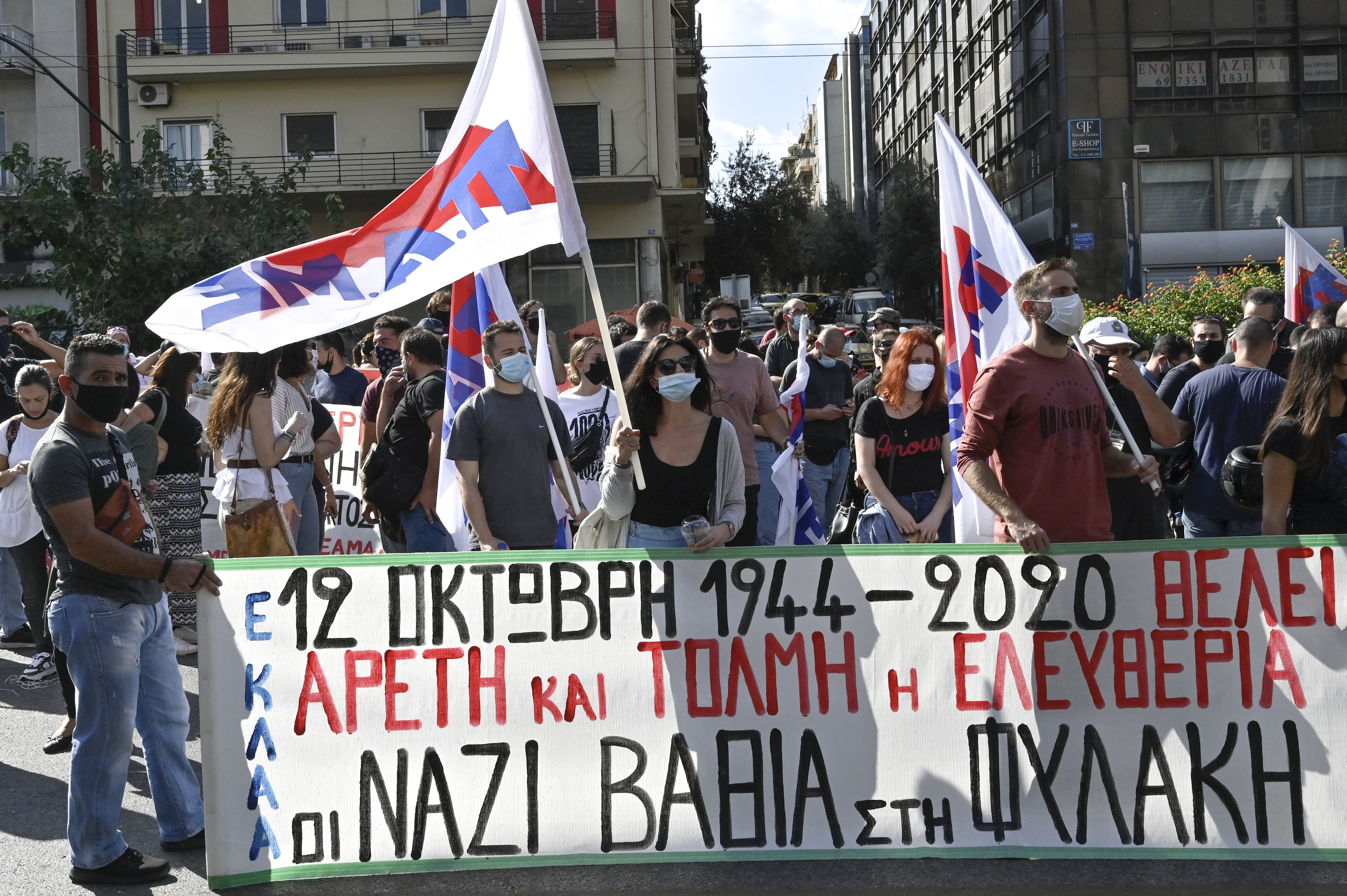 Protestors wearing masks to help protect from the spread of coronavirus, chant slogans during an anti-fascist protest outside a court in Athens, Greece.