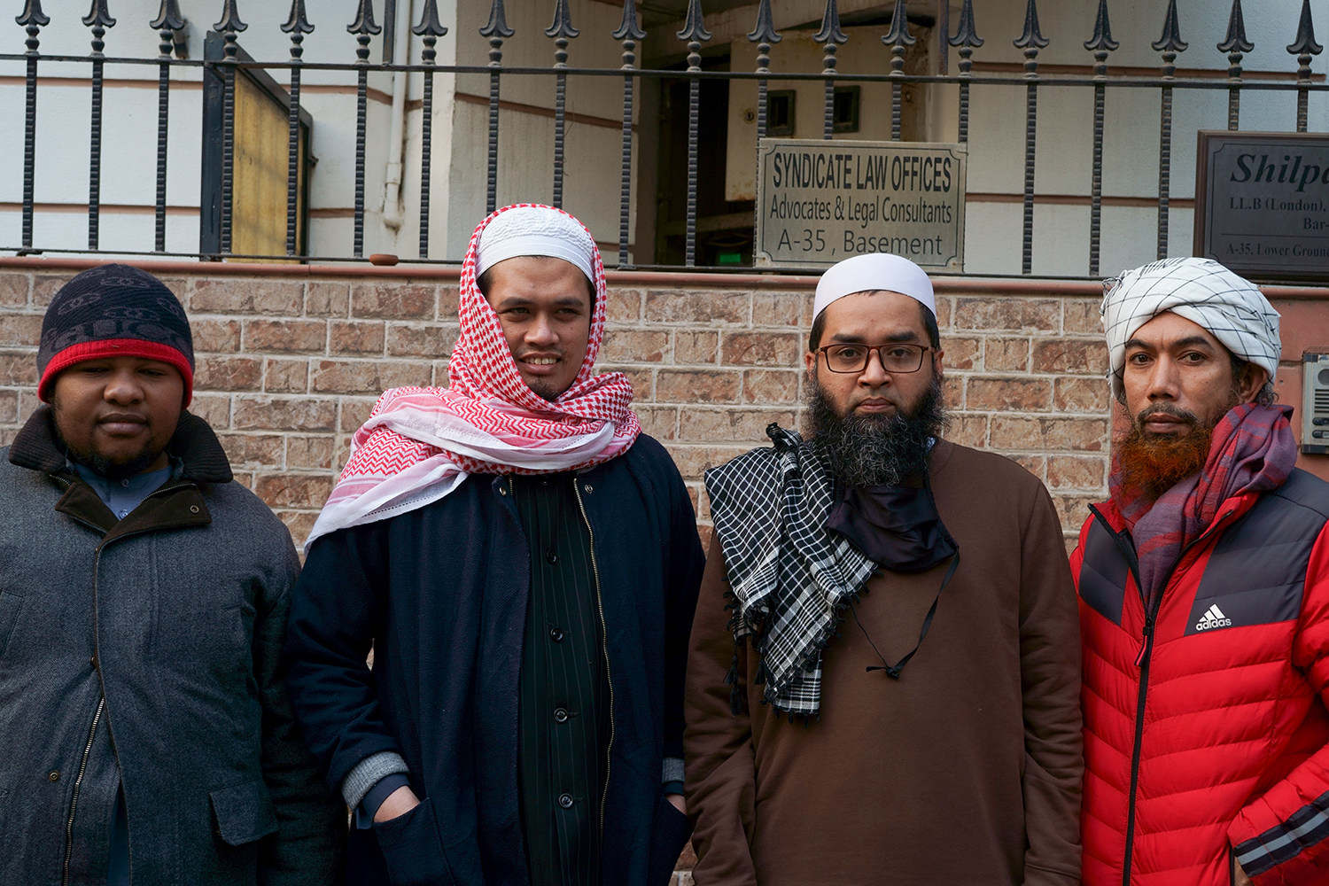 From left to right: Abdullah Ramadan from Tanzania, Rizky Rendhana from Indonesia, Mohammed Faisal from Myanmar, and Salam Maso-Sod from Thailand, who went on trial and were acquitted by Indian courts, pose for a photo in New Delhi [Shaheen Abdulla/Al Jazeera]