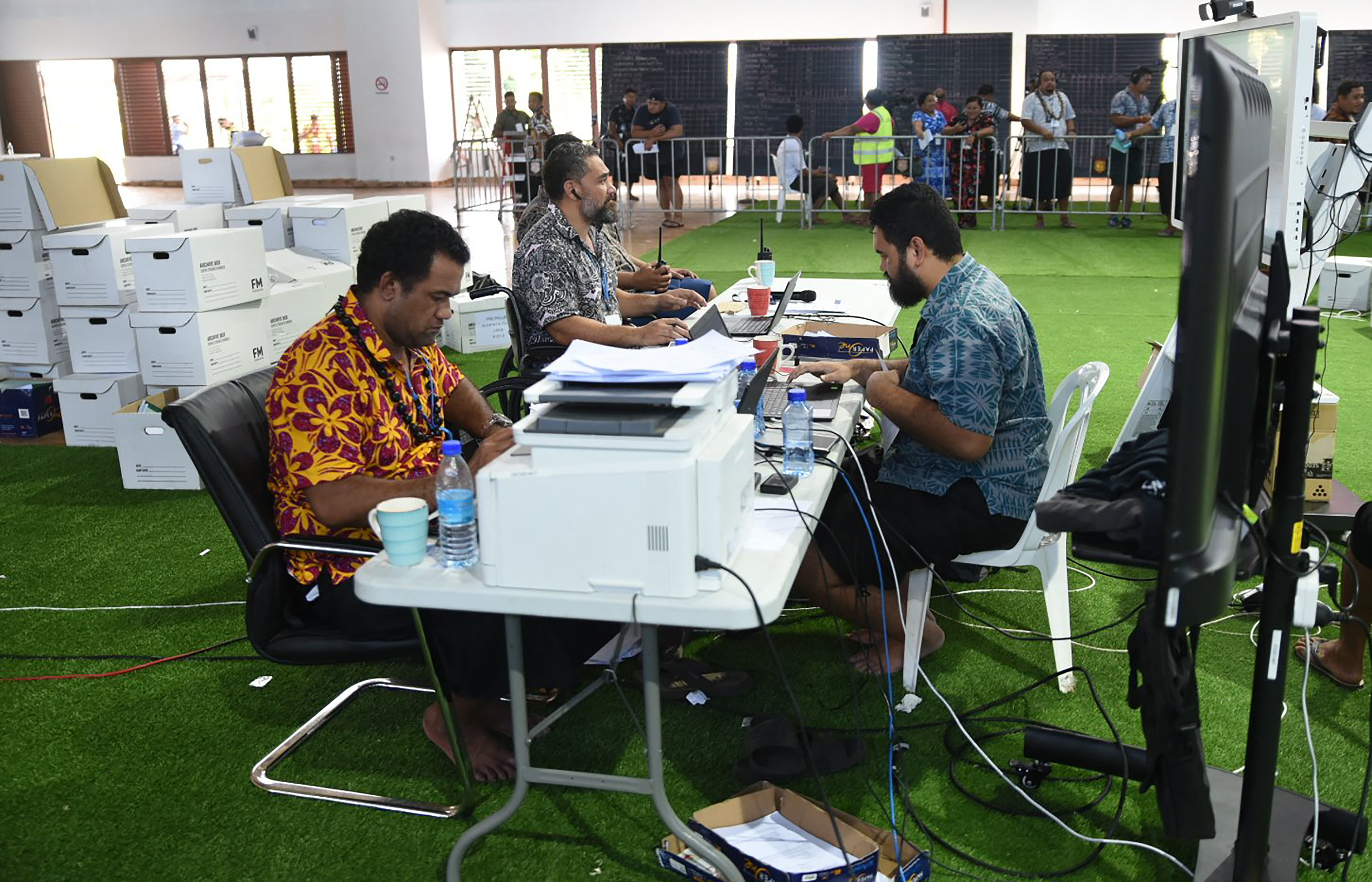 Electoral officials monitoring the counting.