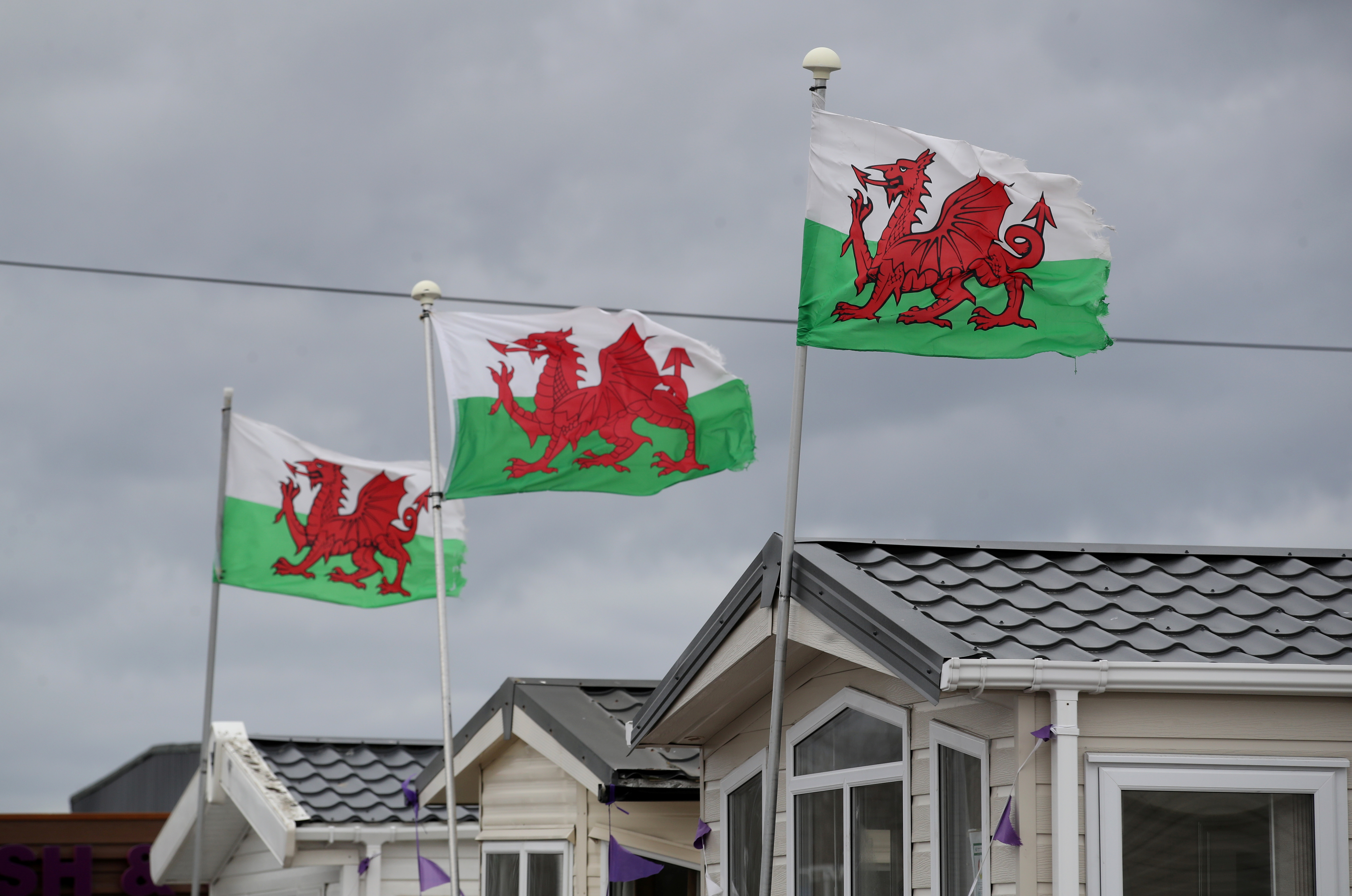 Welsh flags are seen at a closed holiday park in Towyn as the spread of COVID continues [File: Carl Recine/Reuters]