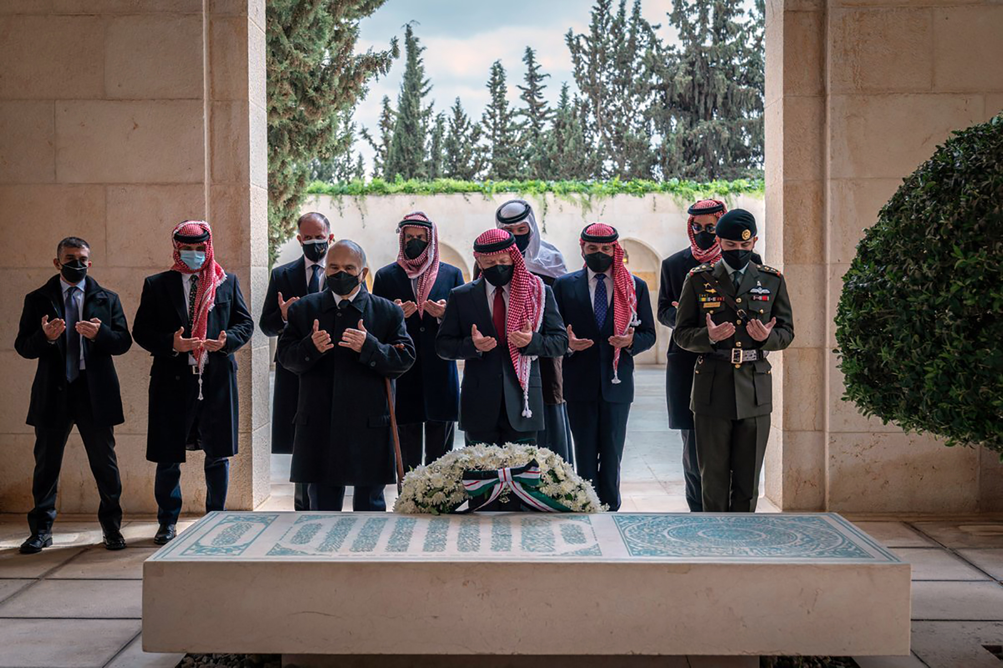 Jordan’s King Abdullah II, centre, Prince Hamzah, second left, and others visit the tomb of the late King Hussein to mark the centenary of the establishment of the Emirate of Transjordan [Royal Court Twitter account via AP]