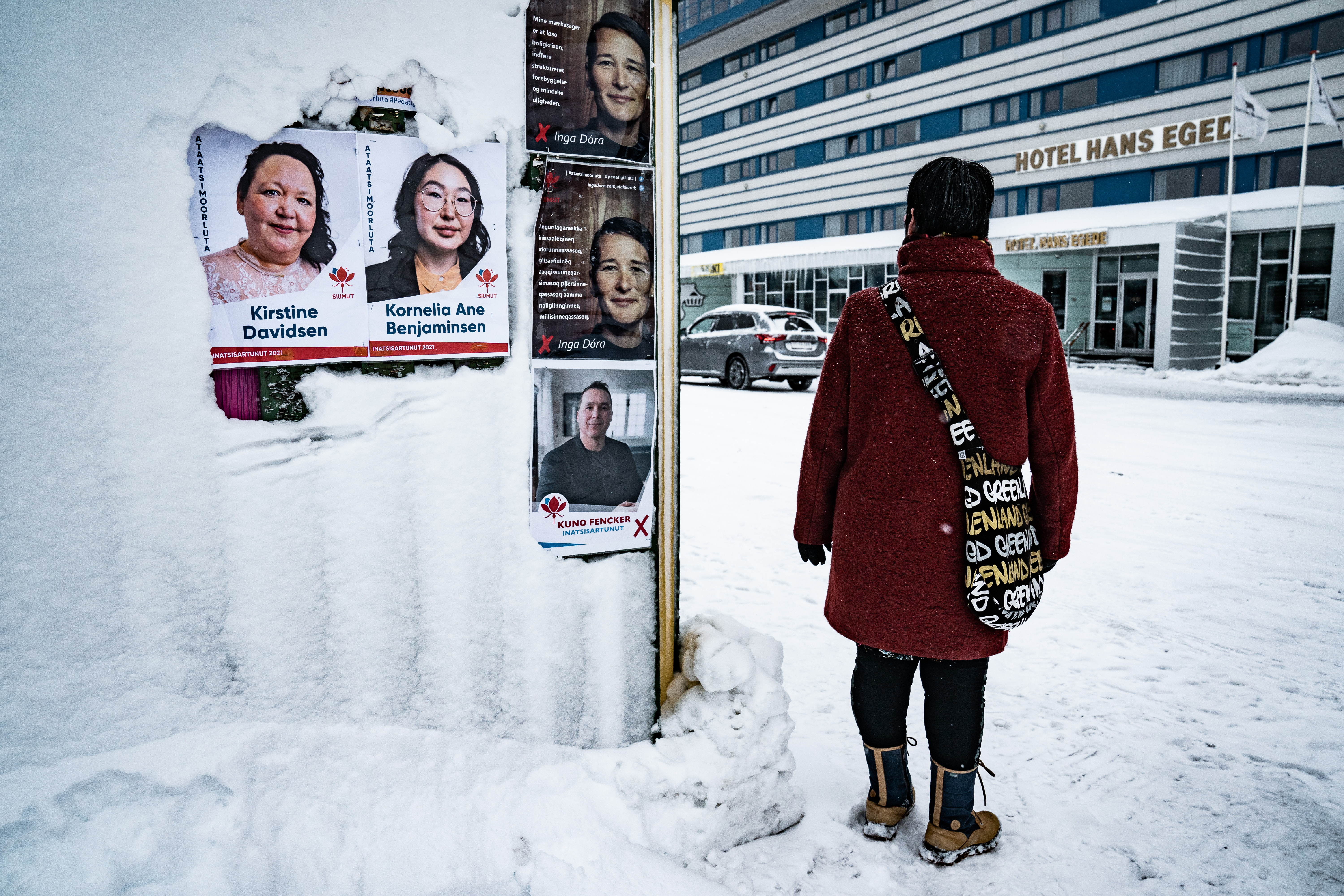 Election posters for Kirstine Davidsen and Kornelia Ane Benjaminsen from the Siumut party in Nuuk, Greenland [Emil Helms/EPA]