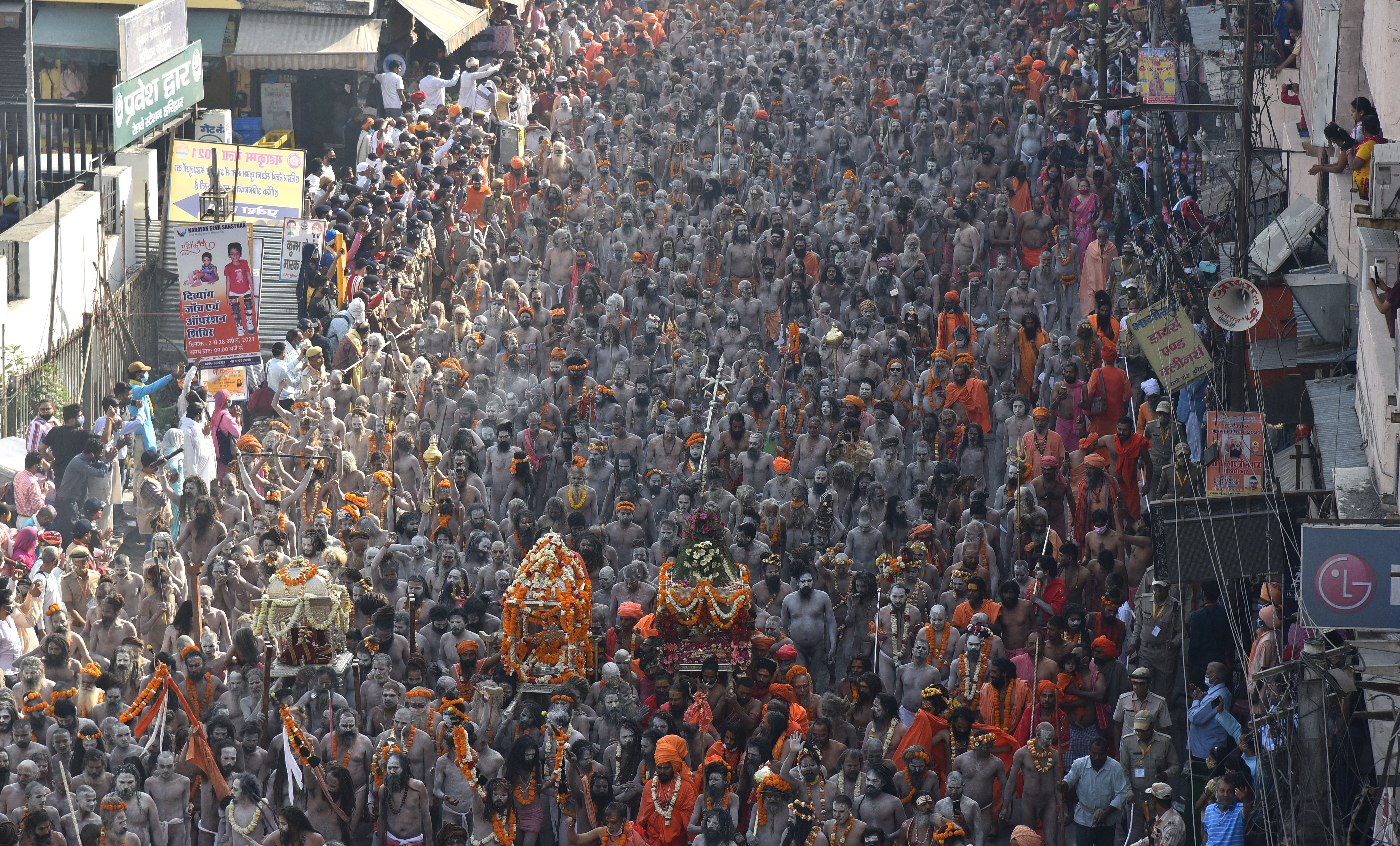 Devotees on their way to take a holy dip in the Ganges River during the Kumbh Mela at Haridwar, Uttarakhand on April 14, 2021 [File: Idrees Mohammed/EPA]