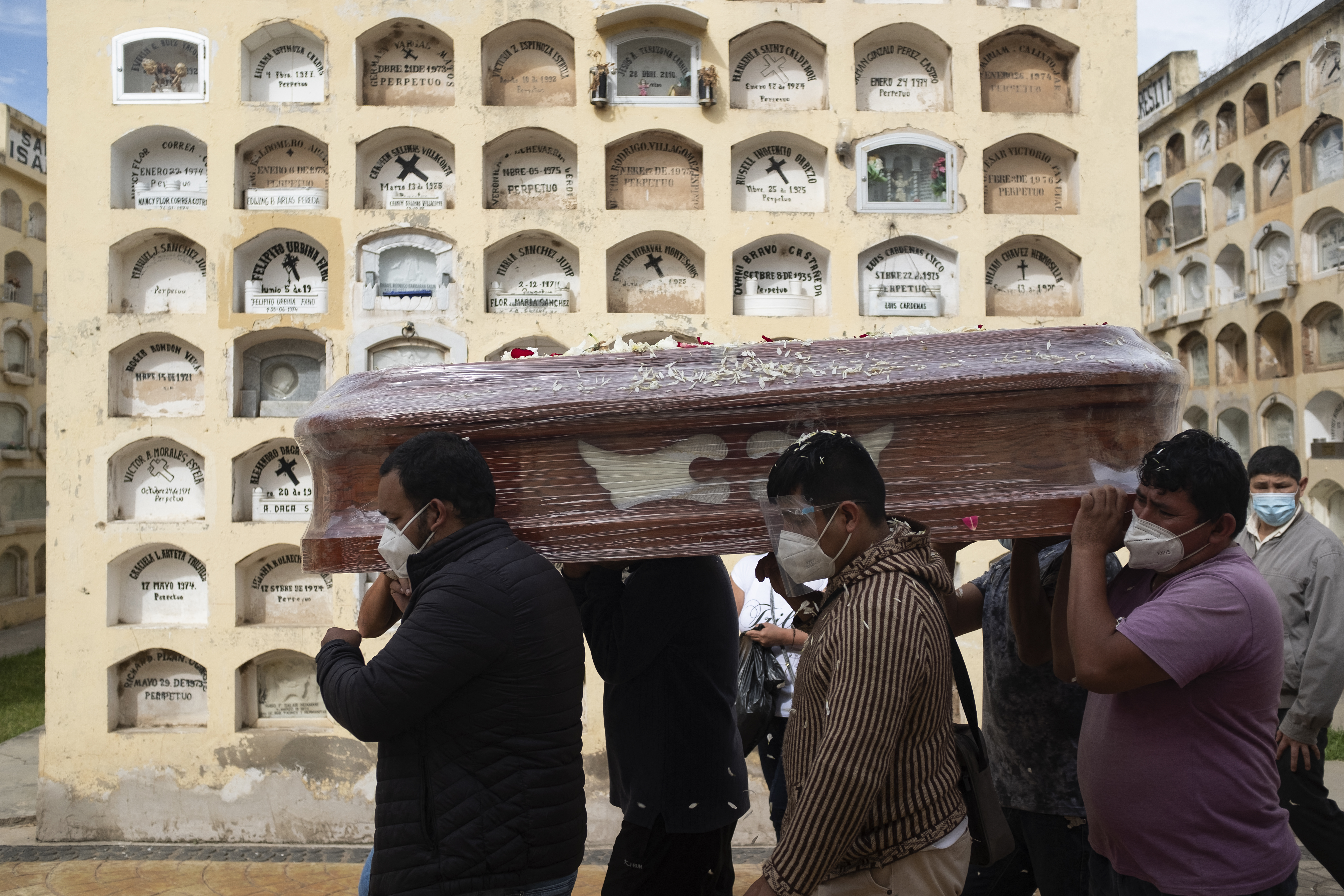 Relatives of a COVID-19 victim carry a coffin at the General Cemetery in the central city of Huanuco, 370 kilometres (230 miles) northeast of Lima, in January [Oscar Rosario/AFP]