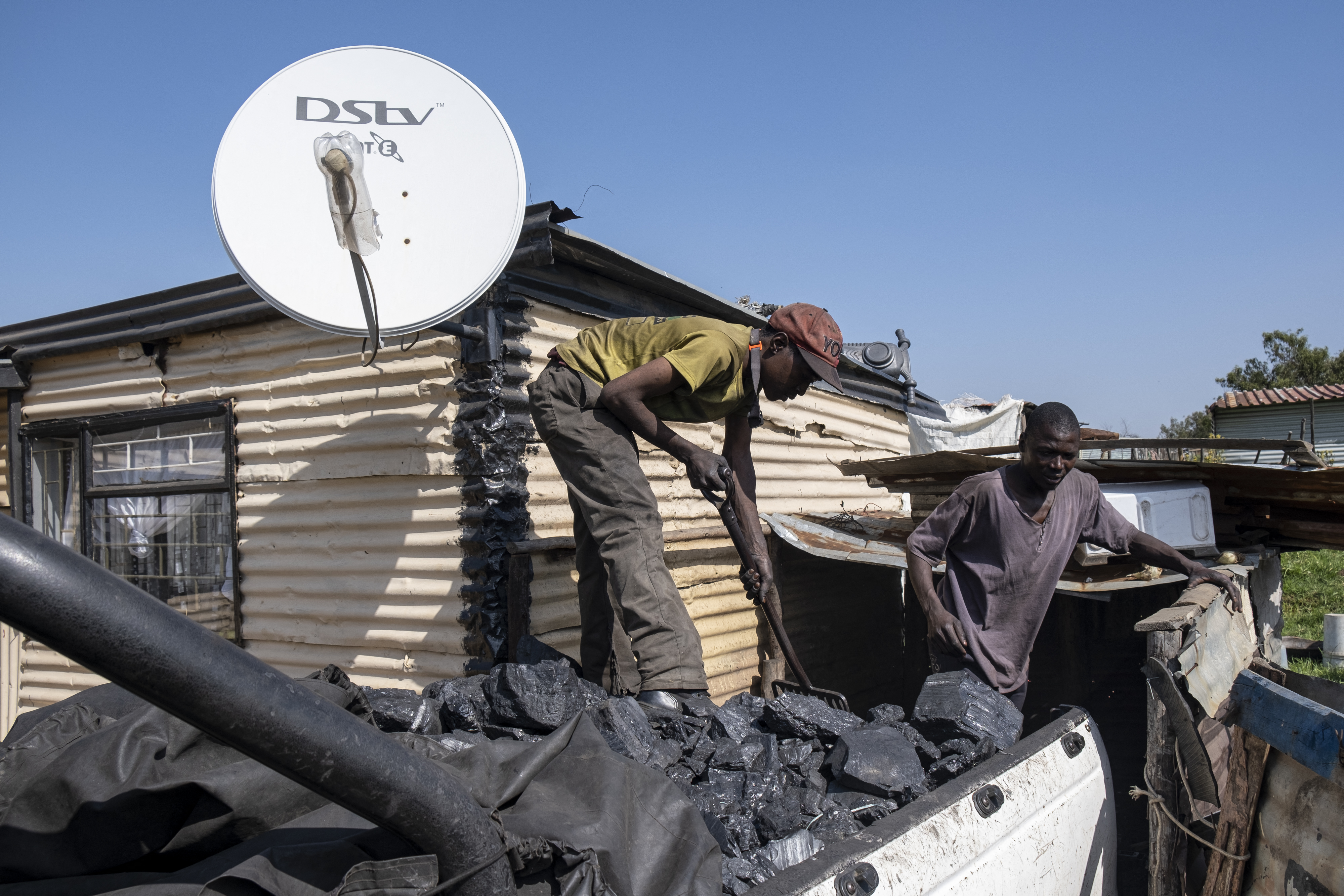 Workers are seen sifting coal in Ermelo, South Africa