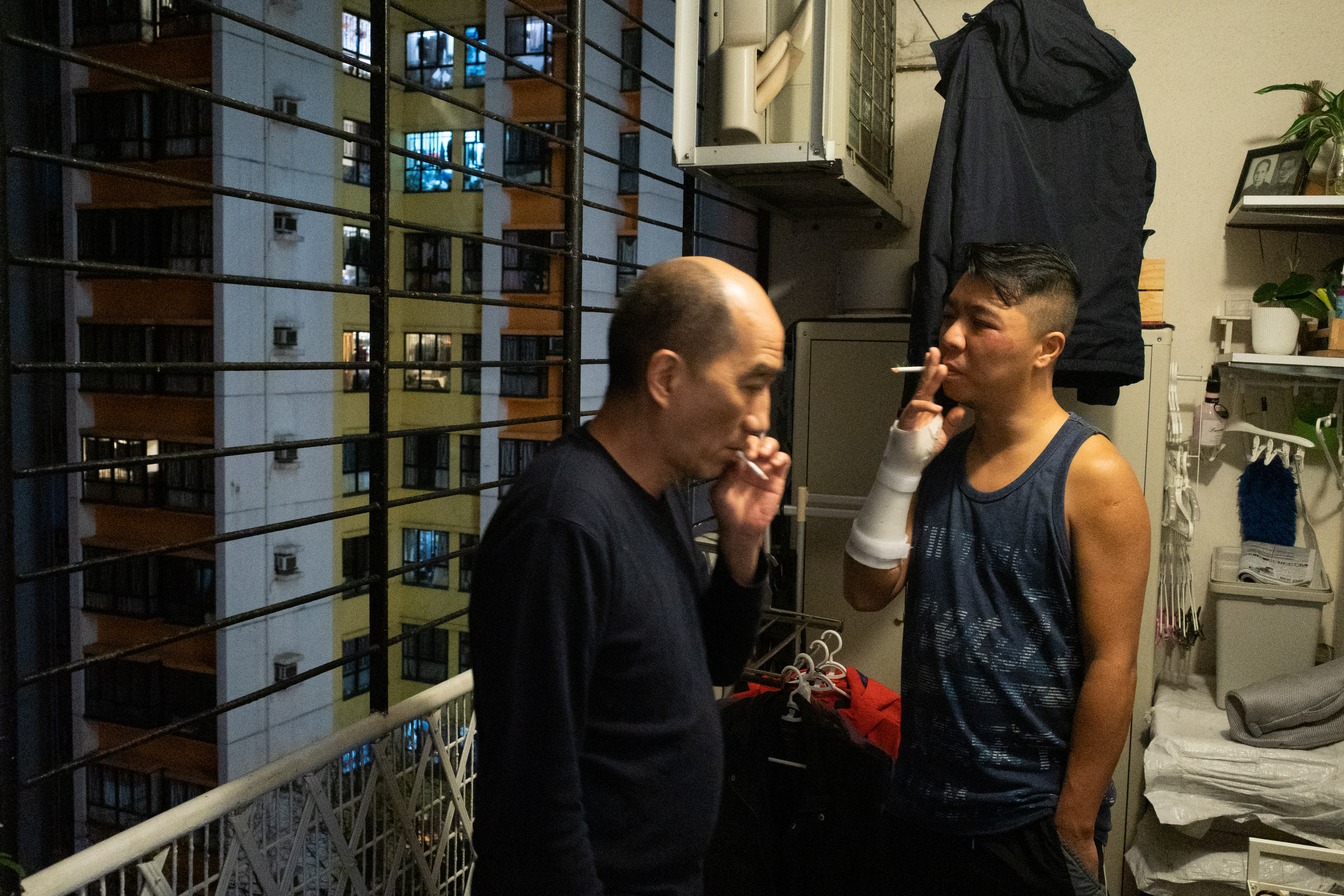 Darkus and his brother-in-law Willie Chan chat after dinner as Willie shares his experience of emigrating to Australia 22 years ago with Darkus. [Bertha Wang/Al Jazeera]