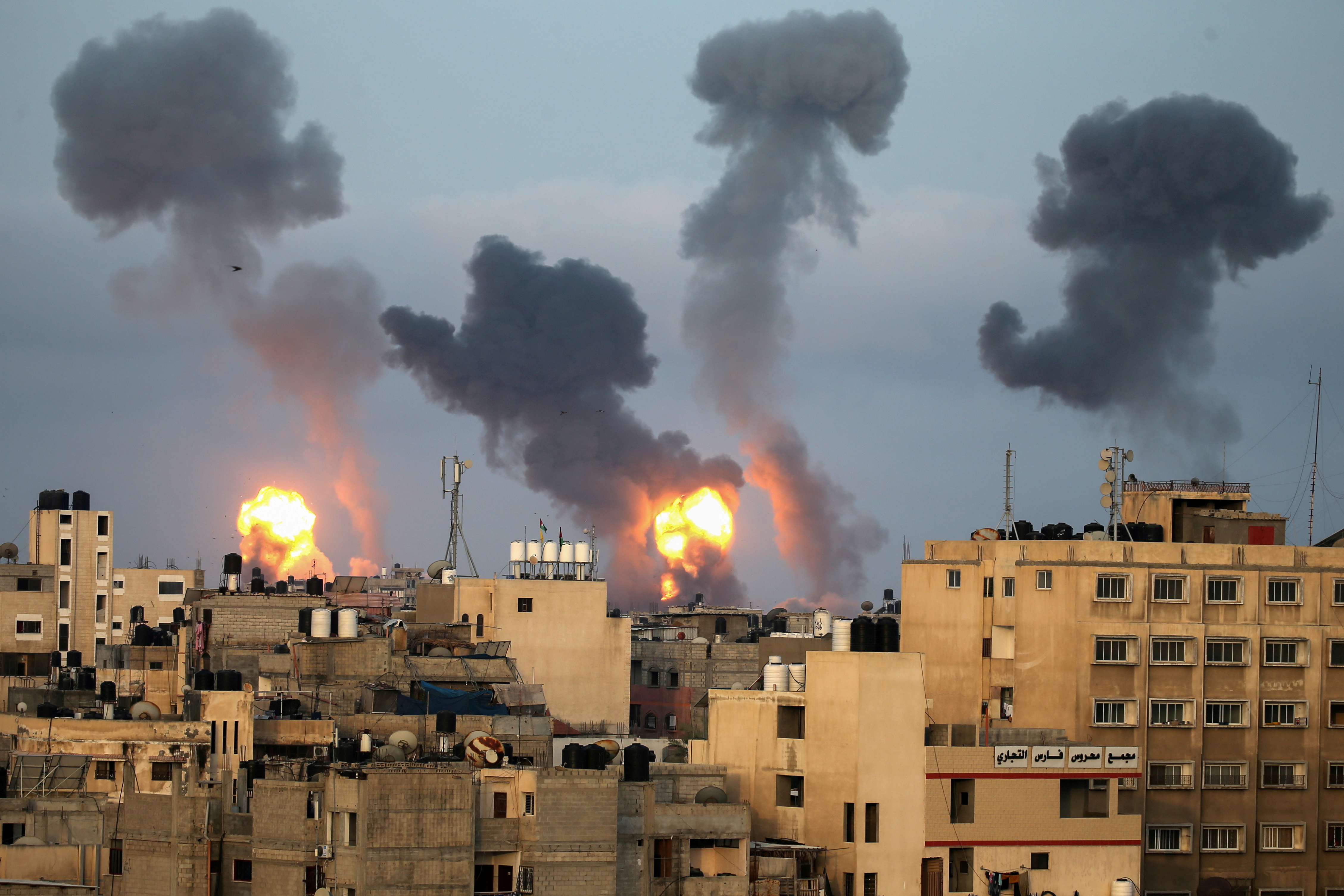 Flames and smoke rise after Israeli air strikes in the southern Gaza Strip May 11, 2021 [Ibraheem Abu Mustafa/Reuters]