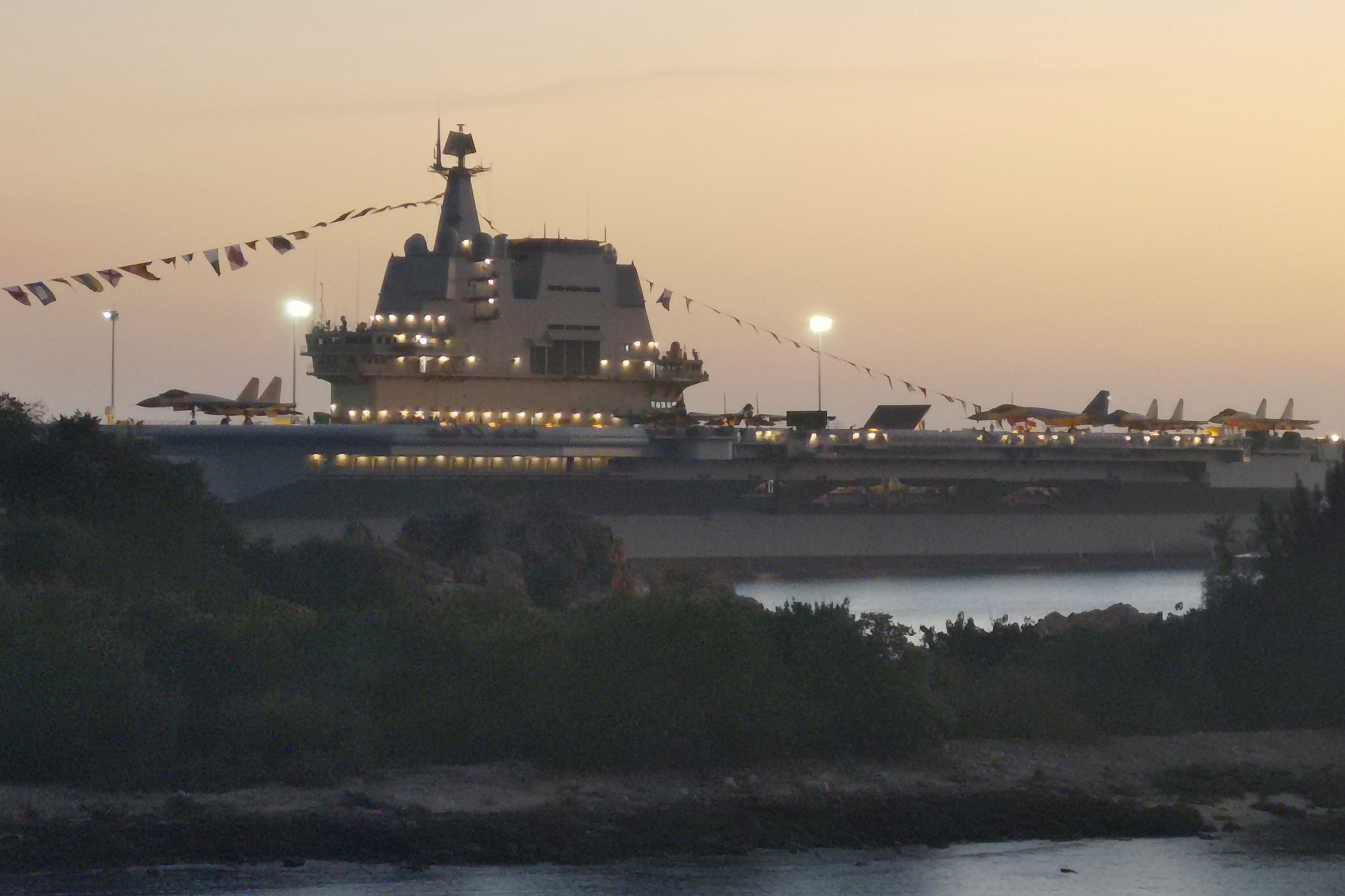 he Shandong aircraft carrier is seen at a naval port in Sanya in southern China's Hainan Province