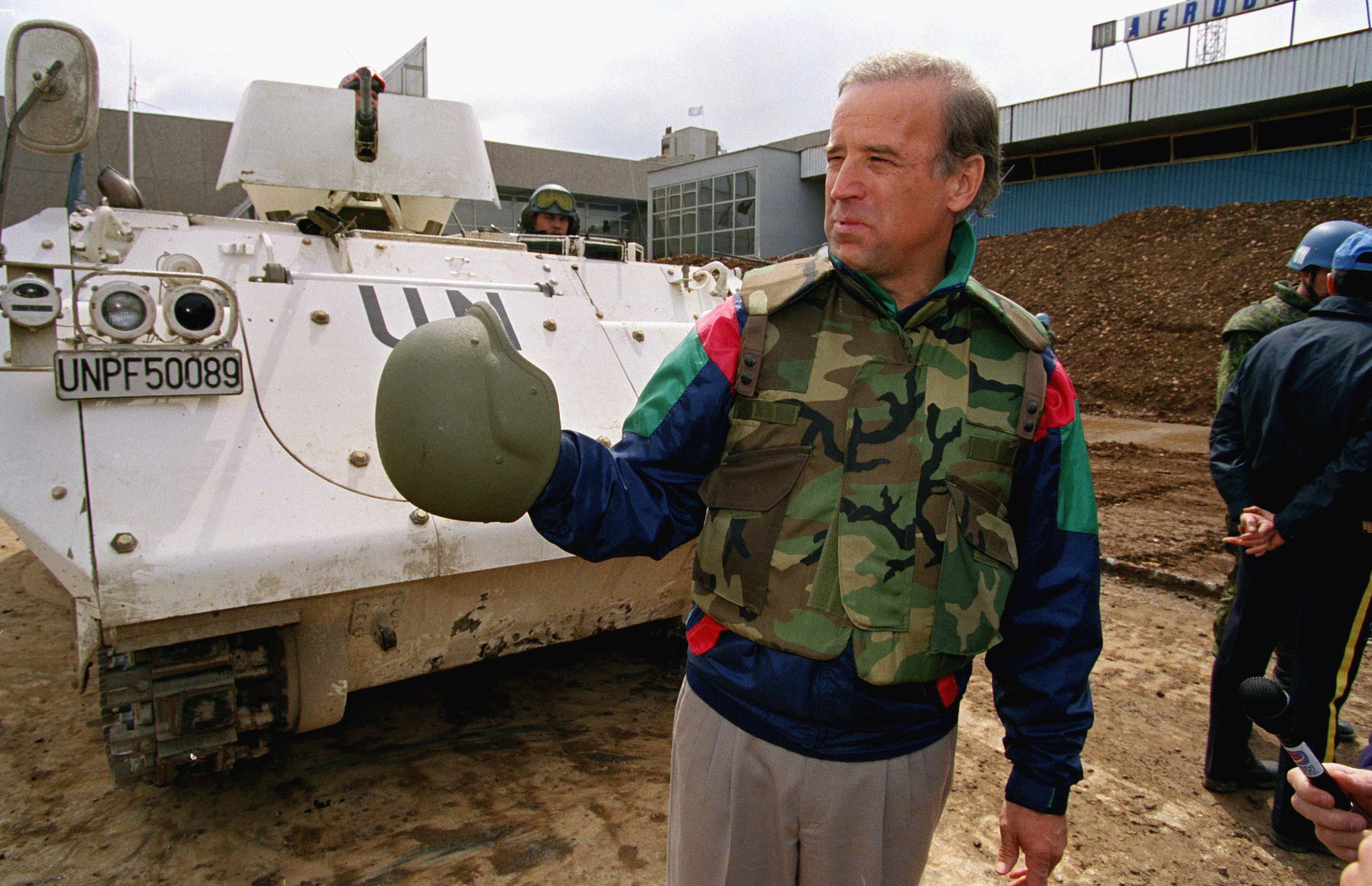 Senator Joe Biden stands in front of a Danish armored personnel carrier at the UN-controlled Sarajevo Airport on April 9, 1993, making a statement about his trip to the besieged Bosnian capital. [File: AP/Michael Stravato]