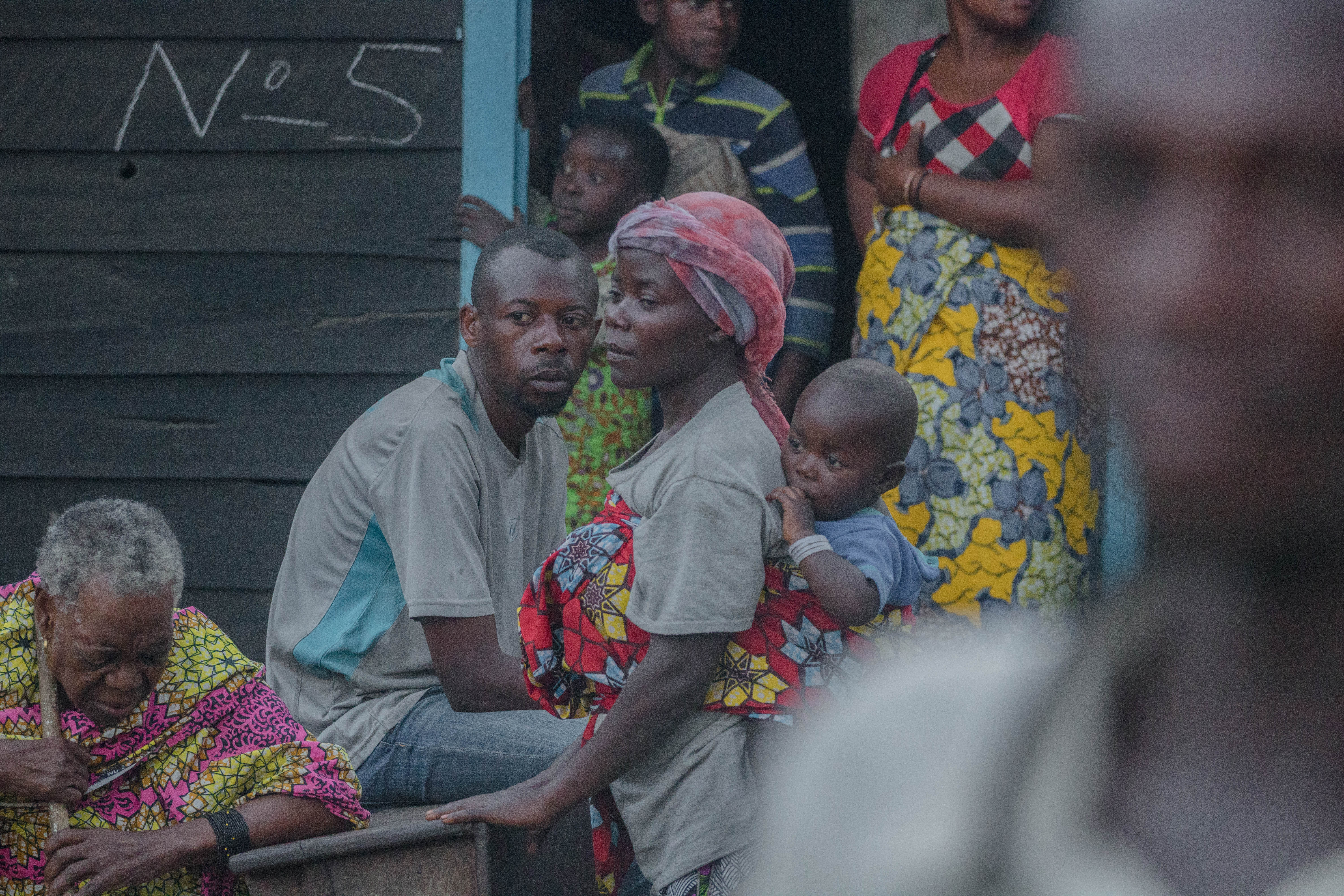 Clarice Matofali, her child on her back, her husband and grandmother after a family discussion on how to leave Sake village following the famine