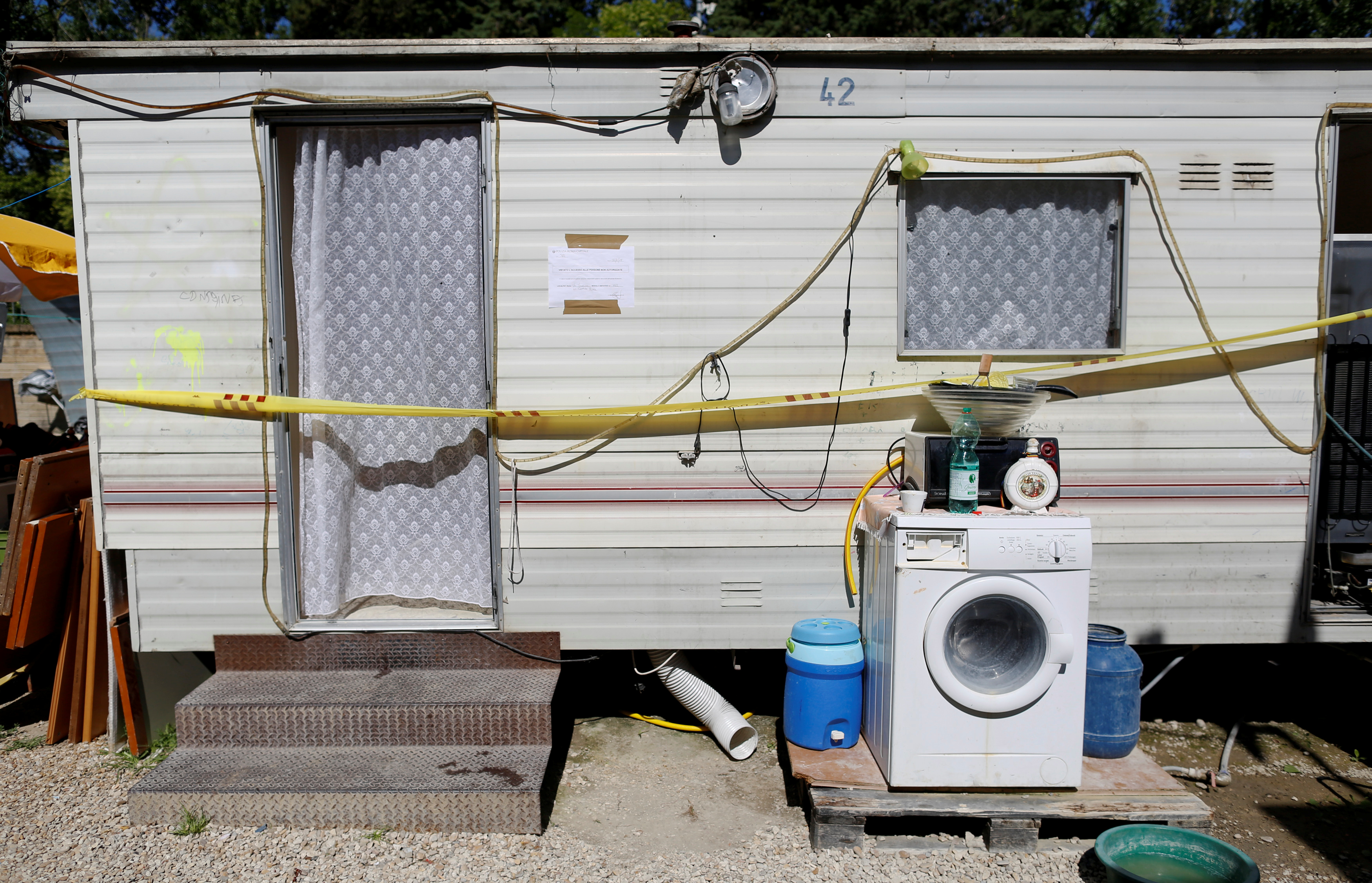 A pre-fabricated home with Police tape blocking entry is seen in an official Roma camp in Rome, Italy June 27, 2018 [Tony Gentile/Reuters]