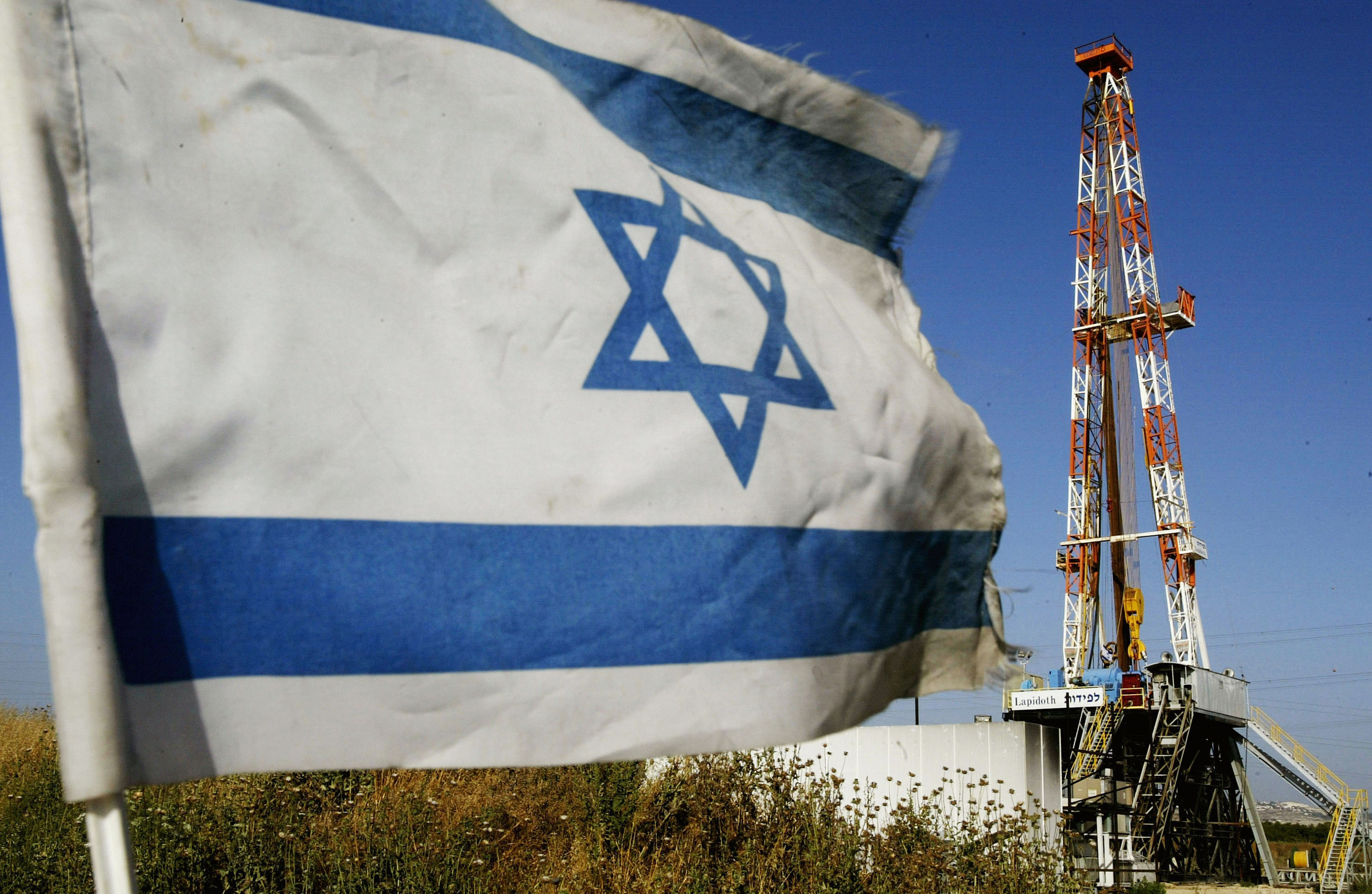 An Israeli flag flies at the Meged oil and natural gas field. Israel says the field lies west of the armistice line of 1948, yet most of the reservoir is situated beneath the Palestinian territory occupied since 1967 [File: David Silverman/Getty Images]