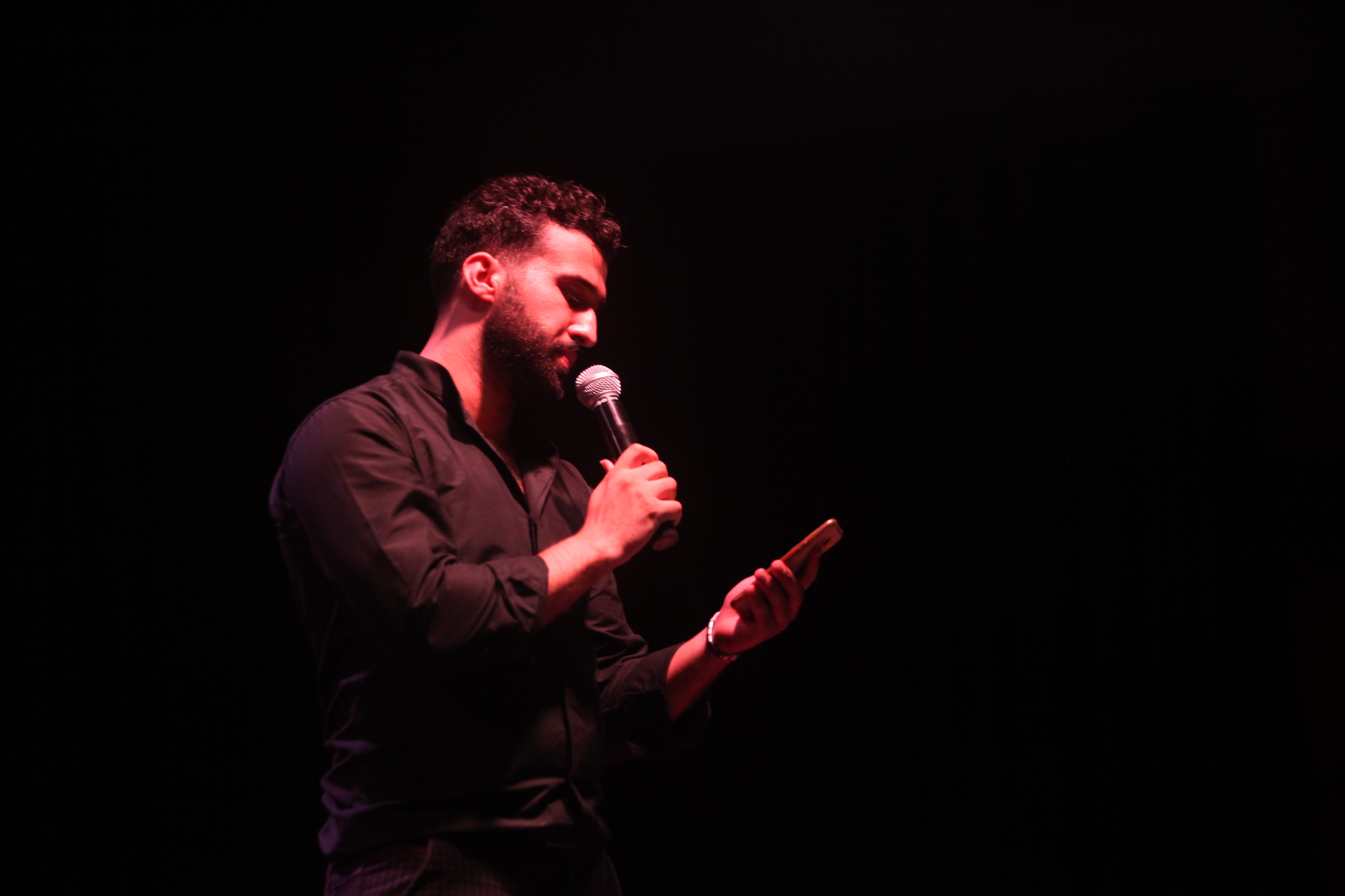 Mohammed Moussa performs poetry during Gaza Youth Speaks, the first spoken word event in Gaza, in July 2018. More than 25 participants performed poetry in English and Arabic [Photo courtesy of Mohammed Moussa]