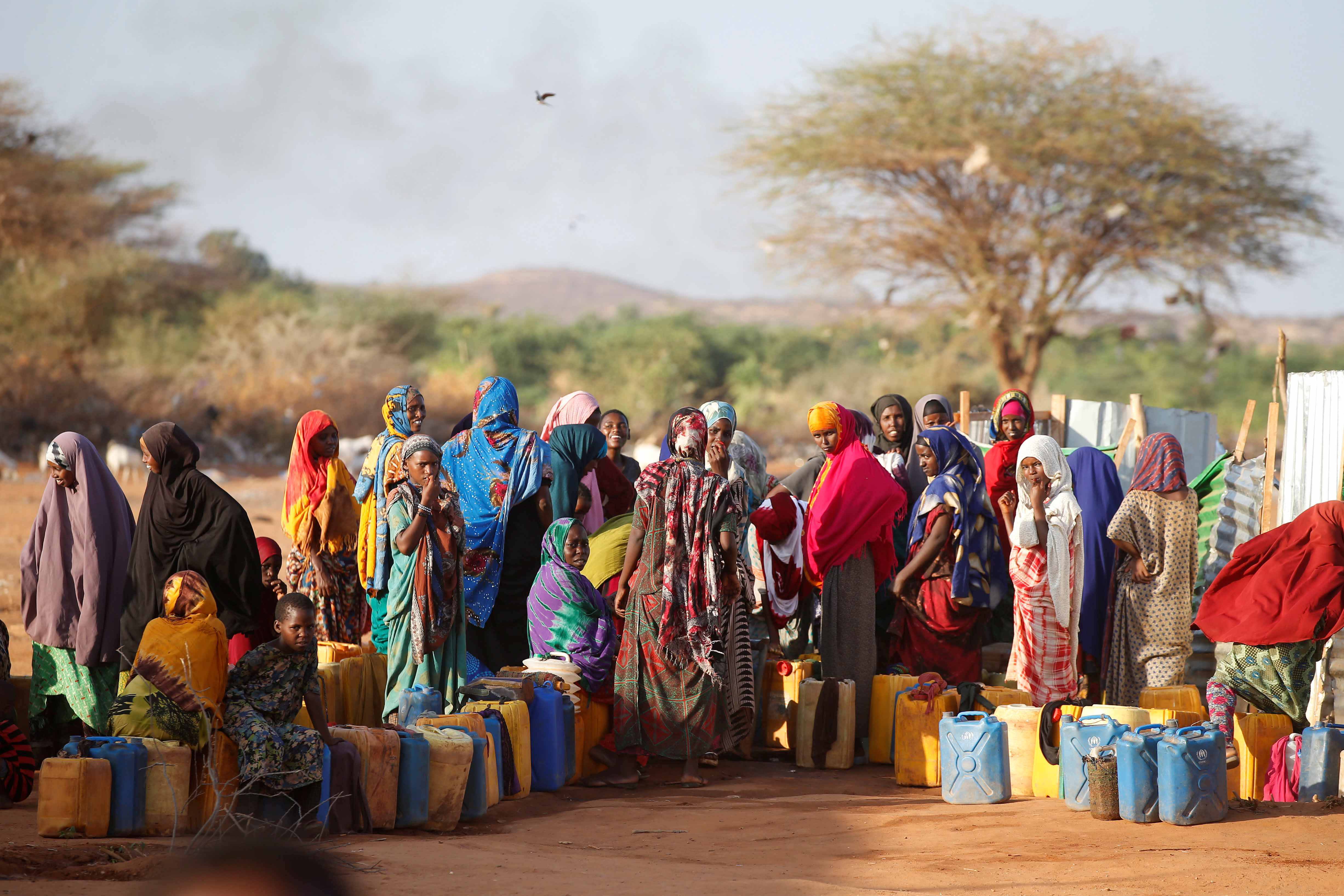 Somali women wait to collect water at the New Kabasa internally displaced camp in the northern Somali town of Dollow, Somalia, on February 25, 2018 [File: Baz Ratner/Reuters]