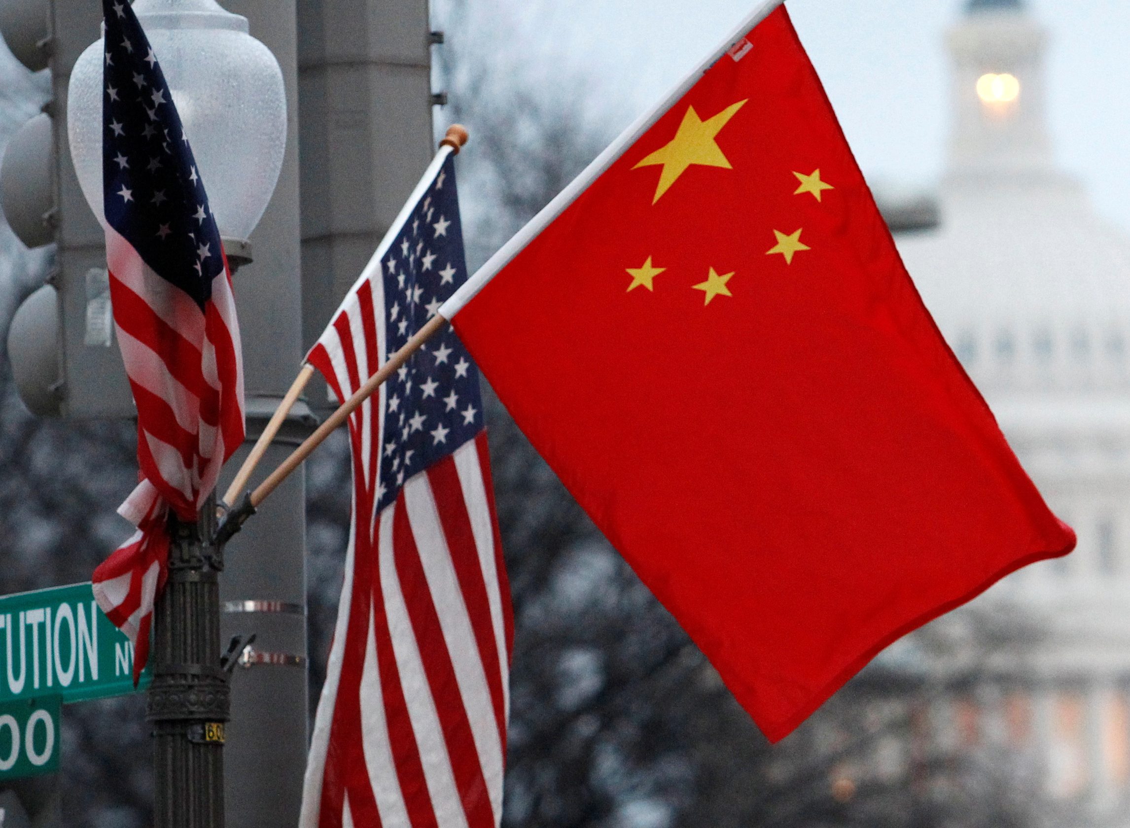 The Chinese and US flags fly on a lamp post along Pennsylvania Avenue near the US Capitol in Washington during then-Chinese President Hu Jintao's state visit in January 2011 [File: Hyungwon Kang/Reuters]