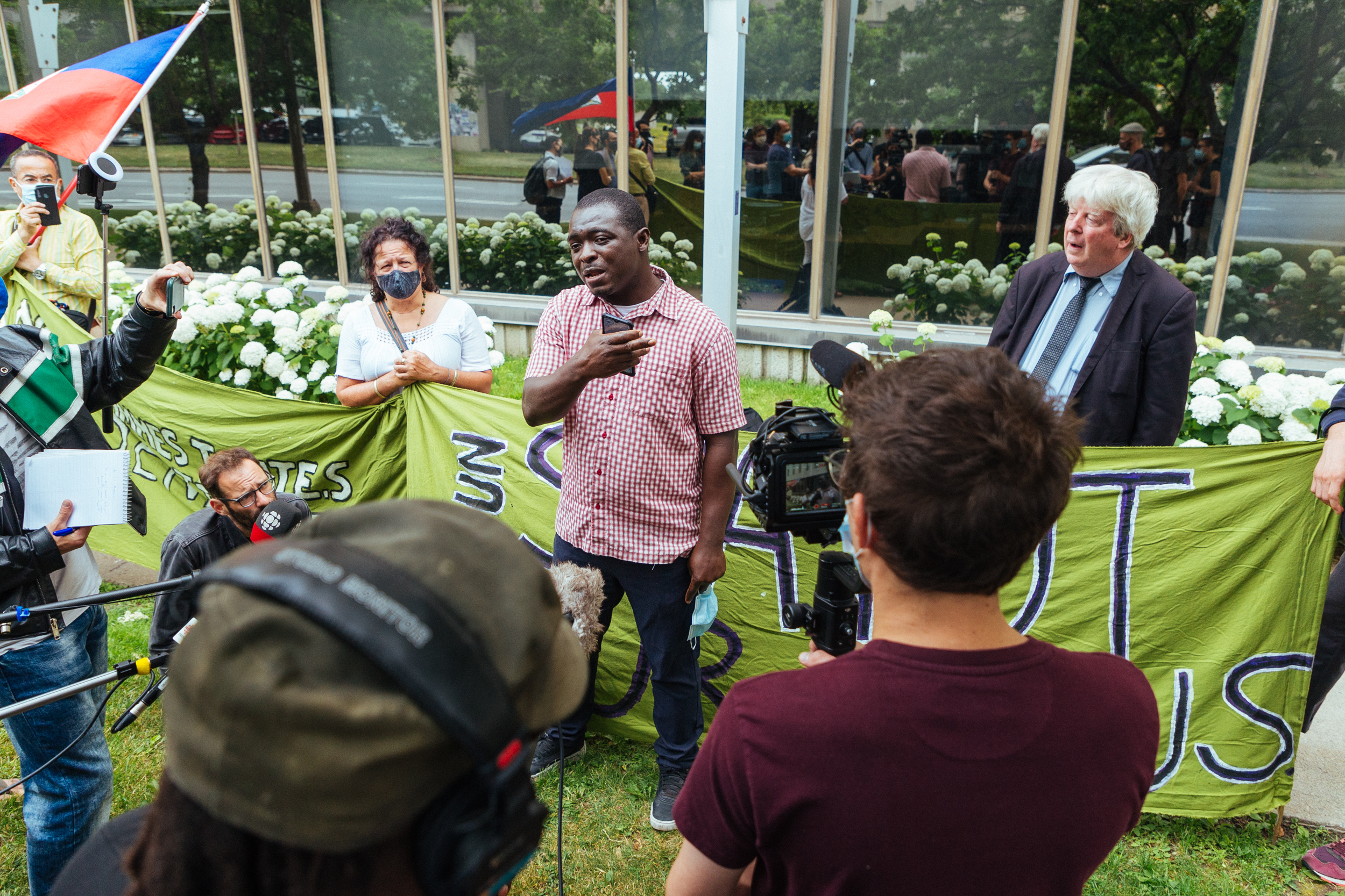 Asylum seeker Mamadou Konaté, worked as a janitor at elderly care homes in Montreal at the peak of the COVID pandemic in 2020, he now faces the threat of deportation. On July 6, he addressed a crowd gathered in front of Prime Minister Trudeau's constituency office in Montreal to protest essential worker deportations [Stacy Lee]