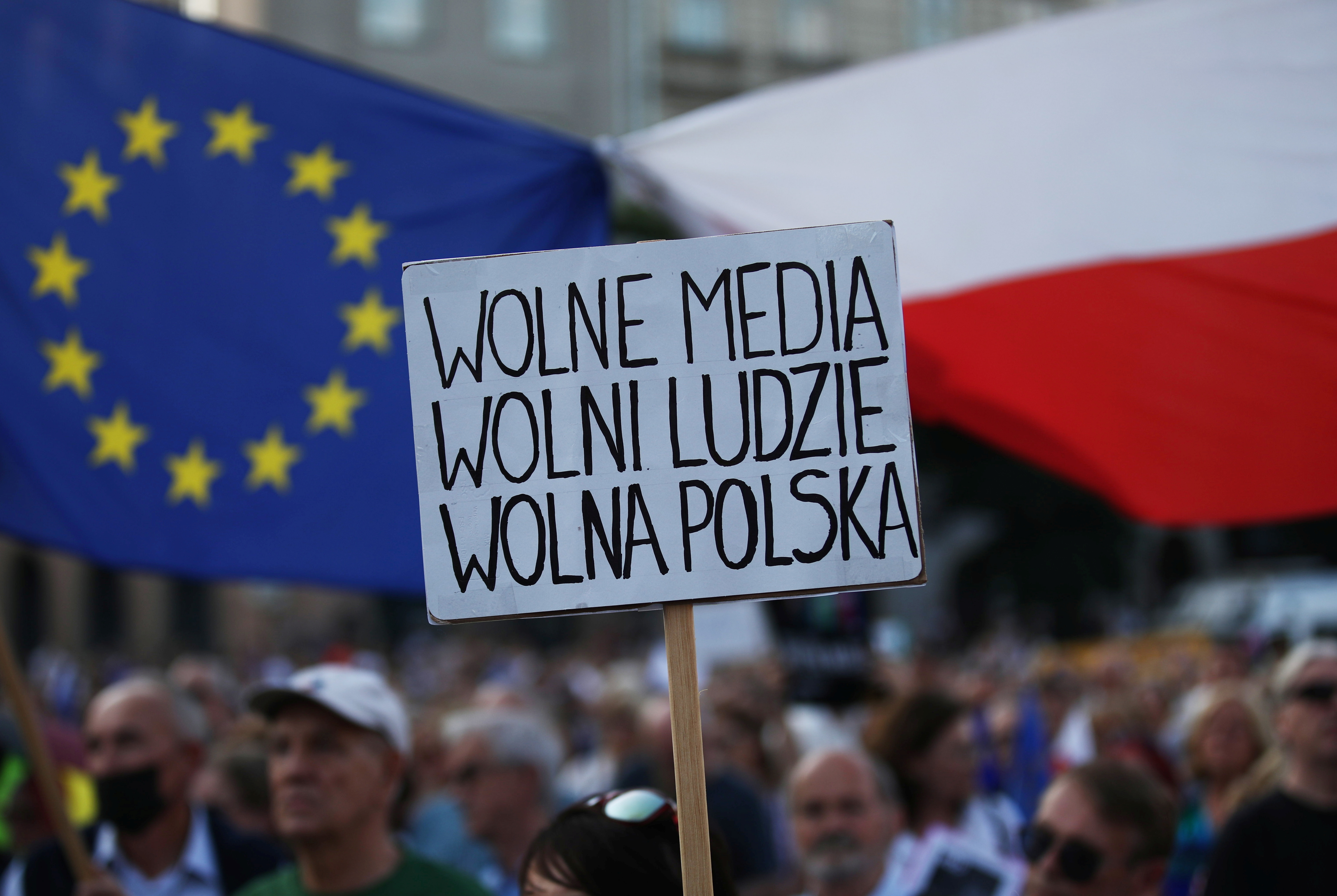 A sign reading "Free media. Free people. Free Poland"