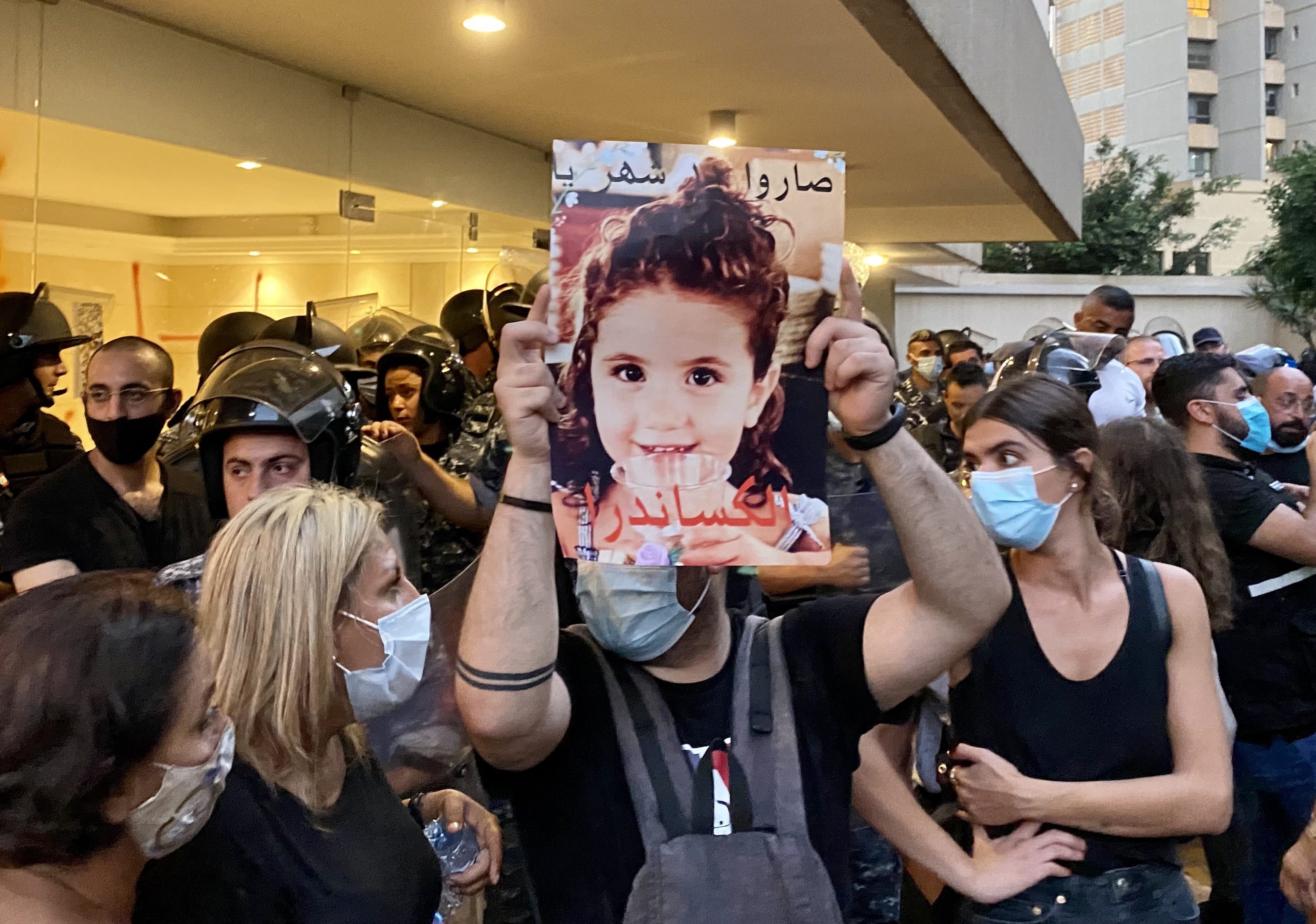 A protester holds up a picture of three year-old Alexandra Naggear, who was killed in the Beirut Port explosion. (Kareem Chehayeb)