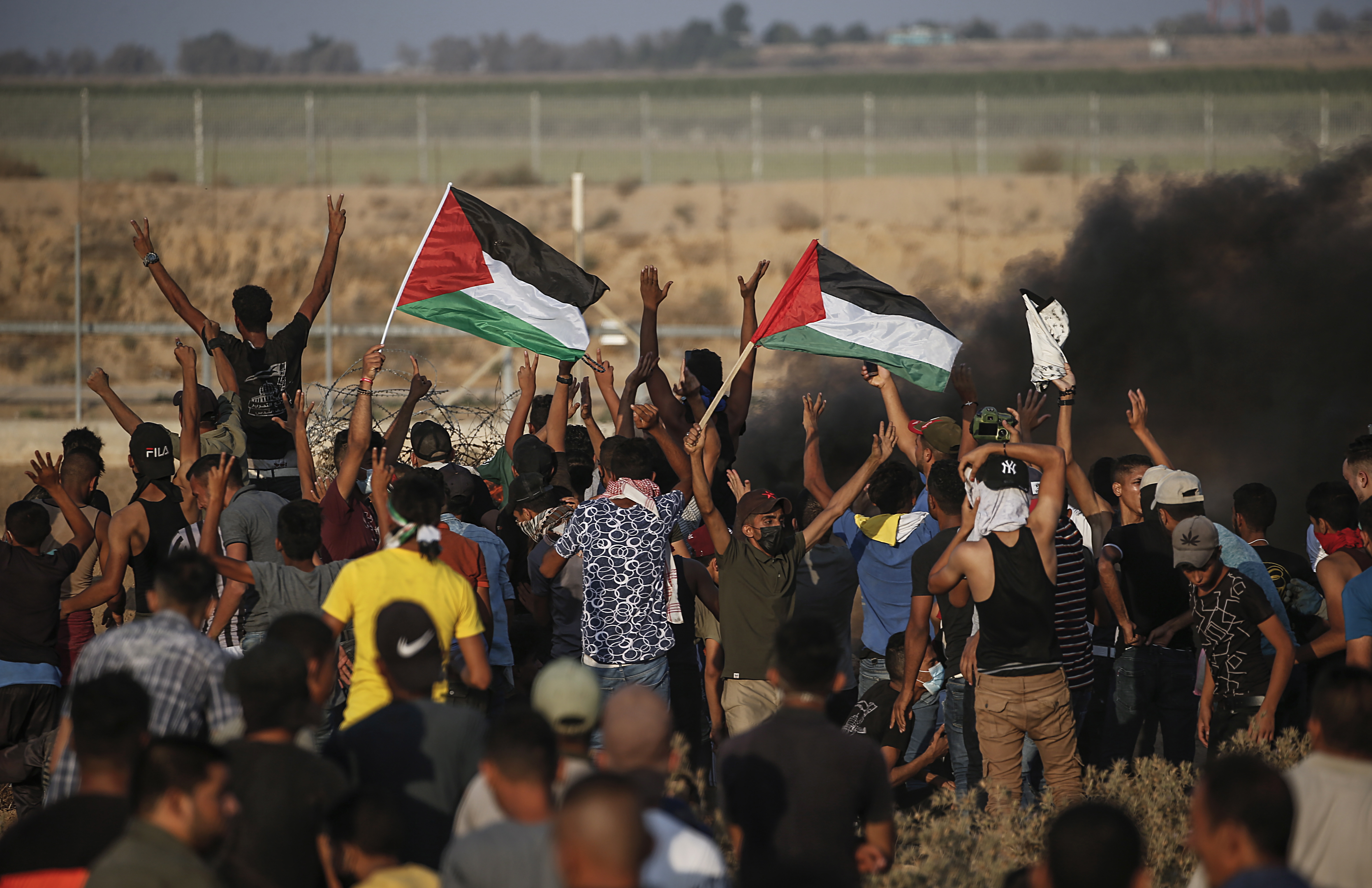 Palestinians protest in eastern Khan Younis town in the southern Gaza Strip in August [EPA]