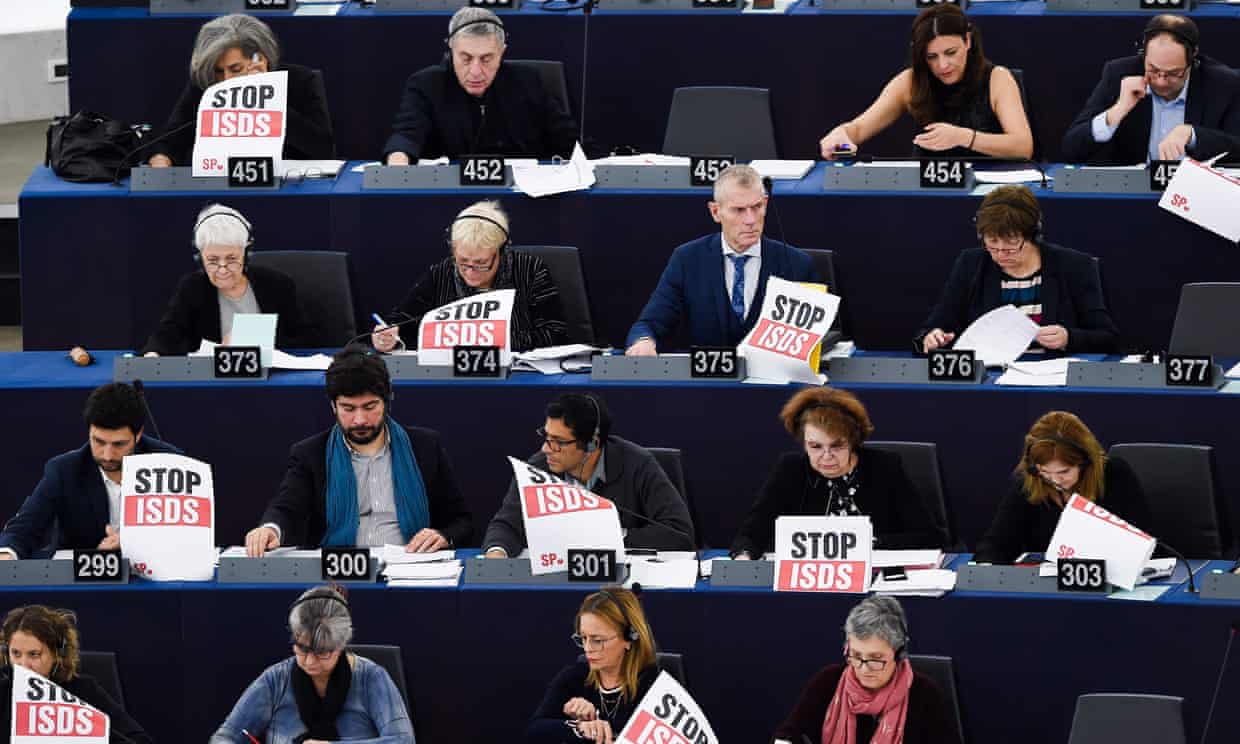 Some members of the European parliament protest against the trade and investment agreement known as the "investor-state dispute settlement" (ISDS), which creates a "corporate court" allowing multinational corporations from a trade partner country to sue a government in a tribunal for any law or regulation they regard as unfair.[Frederick Florin/Pool via Getty]